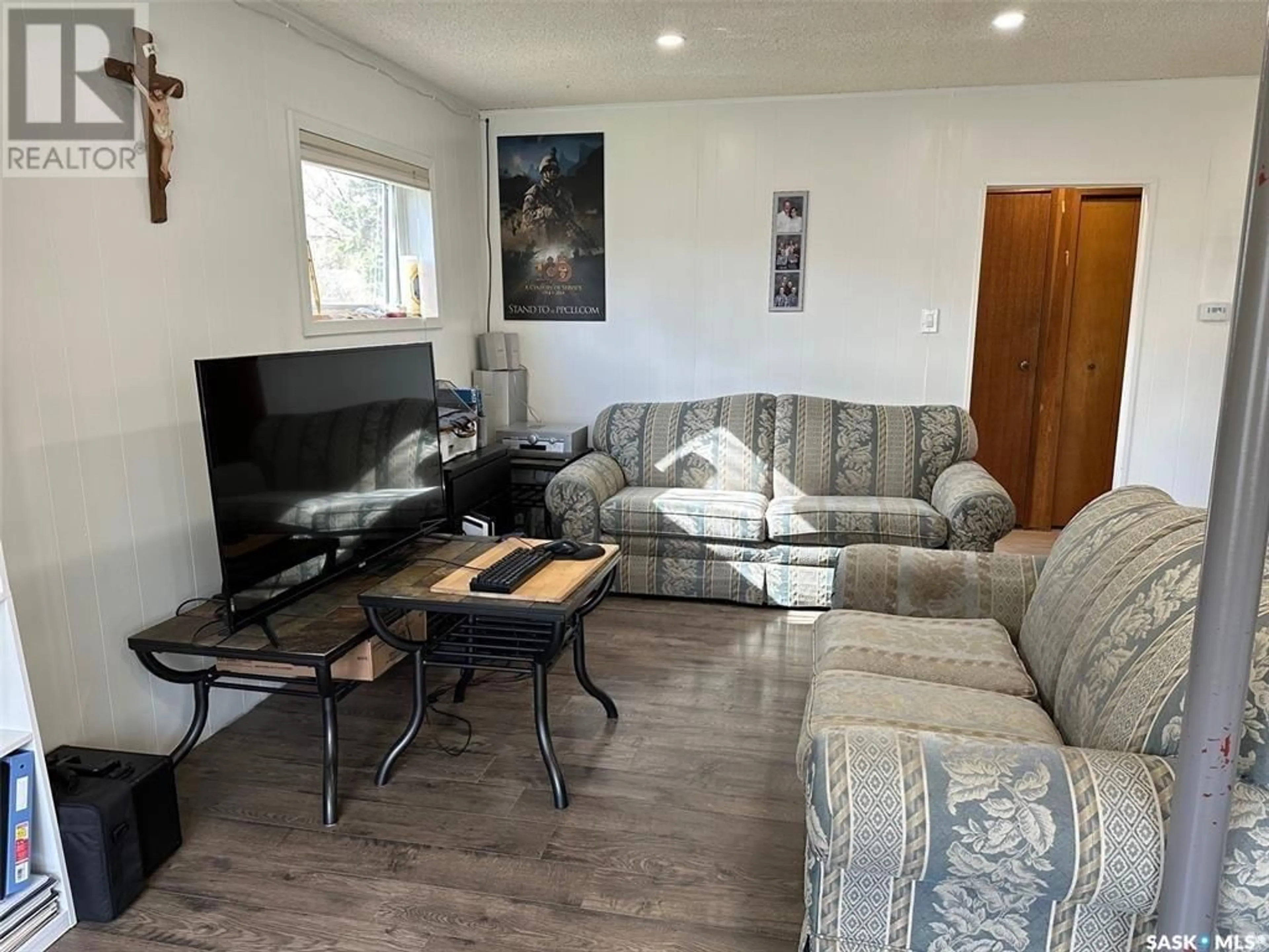 Living room with furniture, wood/laminate floor for 301 BELFAST STREET, North Portal Saskatchewan S0C1N0