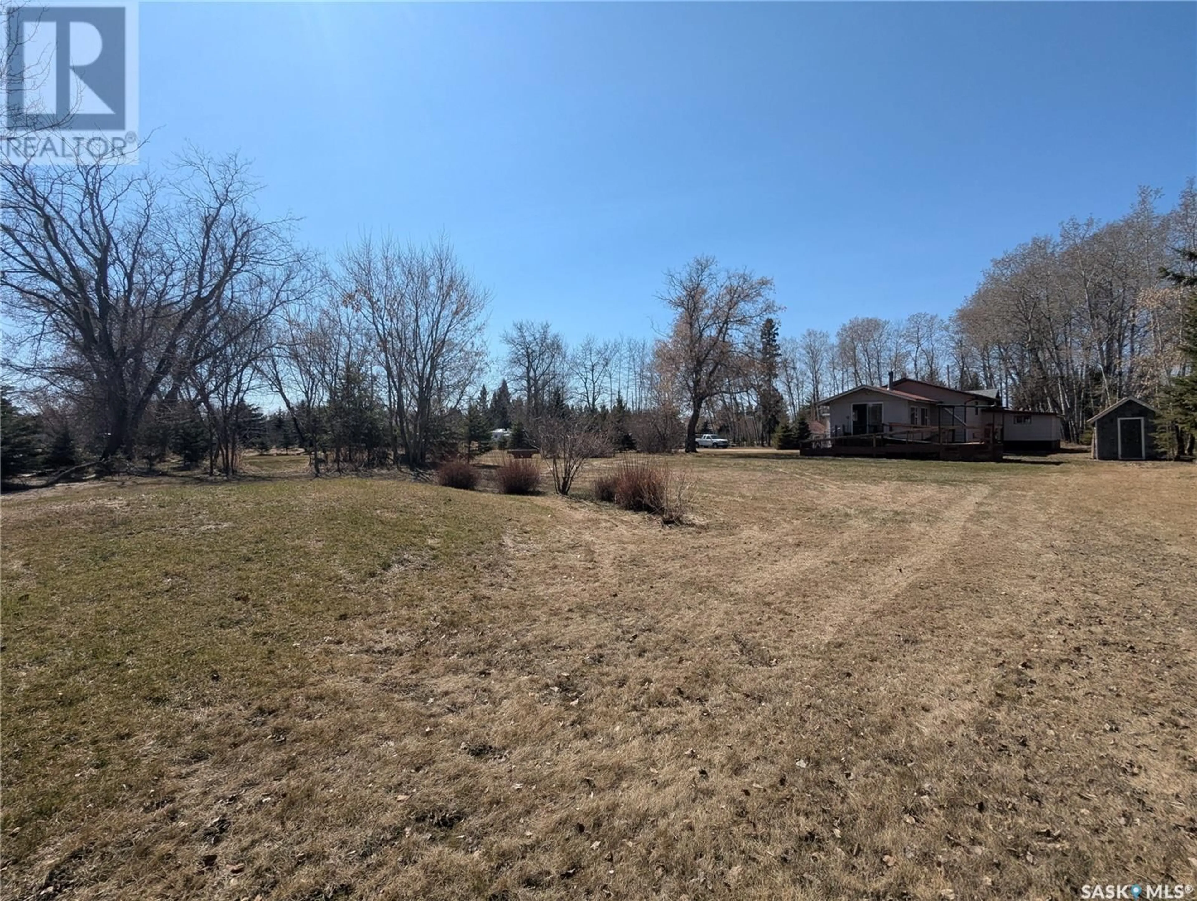 A pic from outside/outdoor area/front of a property/back of a property/a pic from drone, forest/trees view for 129 LEMIEUX CRESCENT, Leoville Saskatchewan S0J1N0