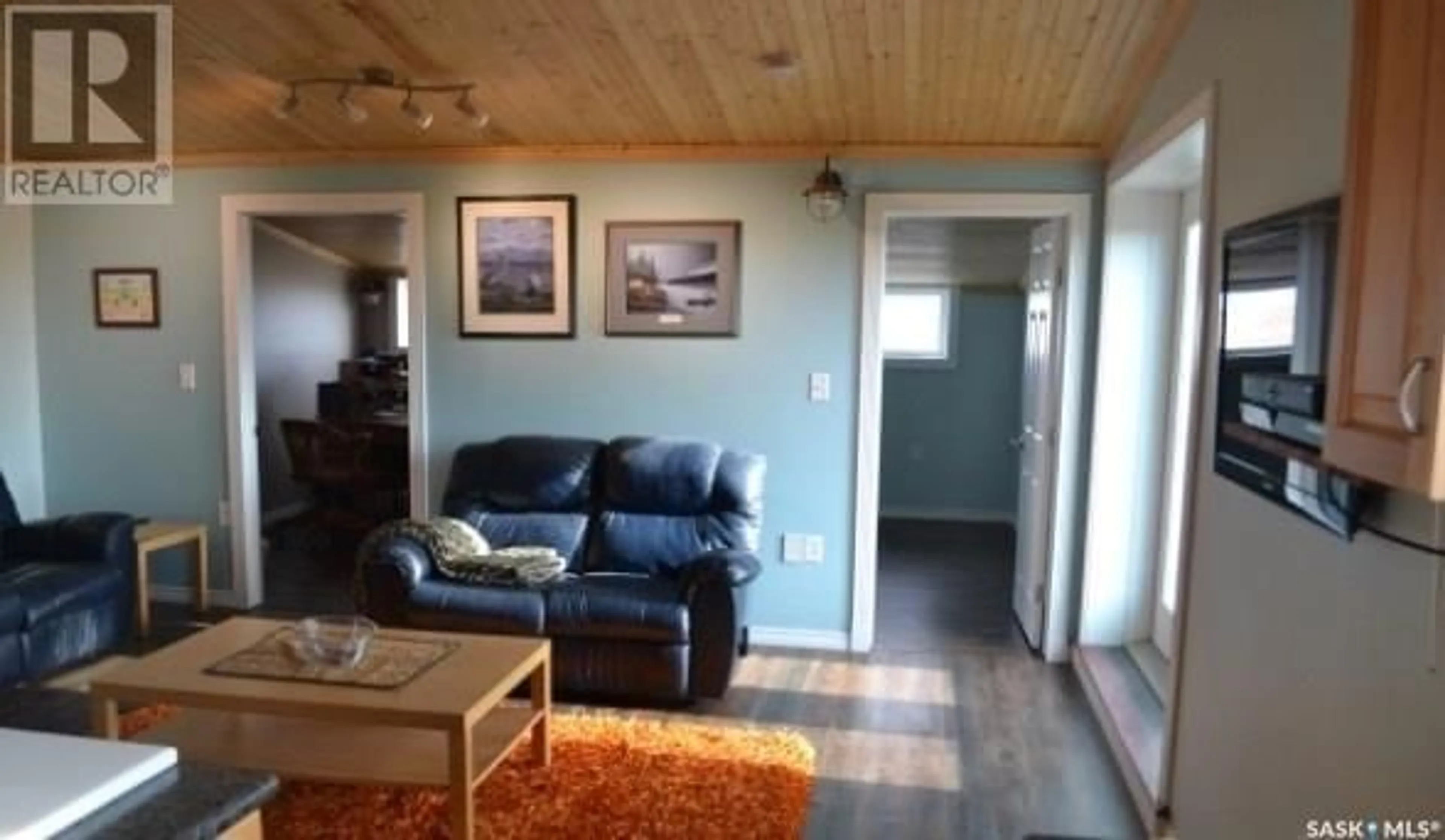 Living room with furniture, wood/laminate floor for AIRCRAFT HANGAR ACREAGE, Aberdeen Rm No. 373 Saskatchewan S0K0A0
