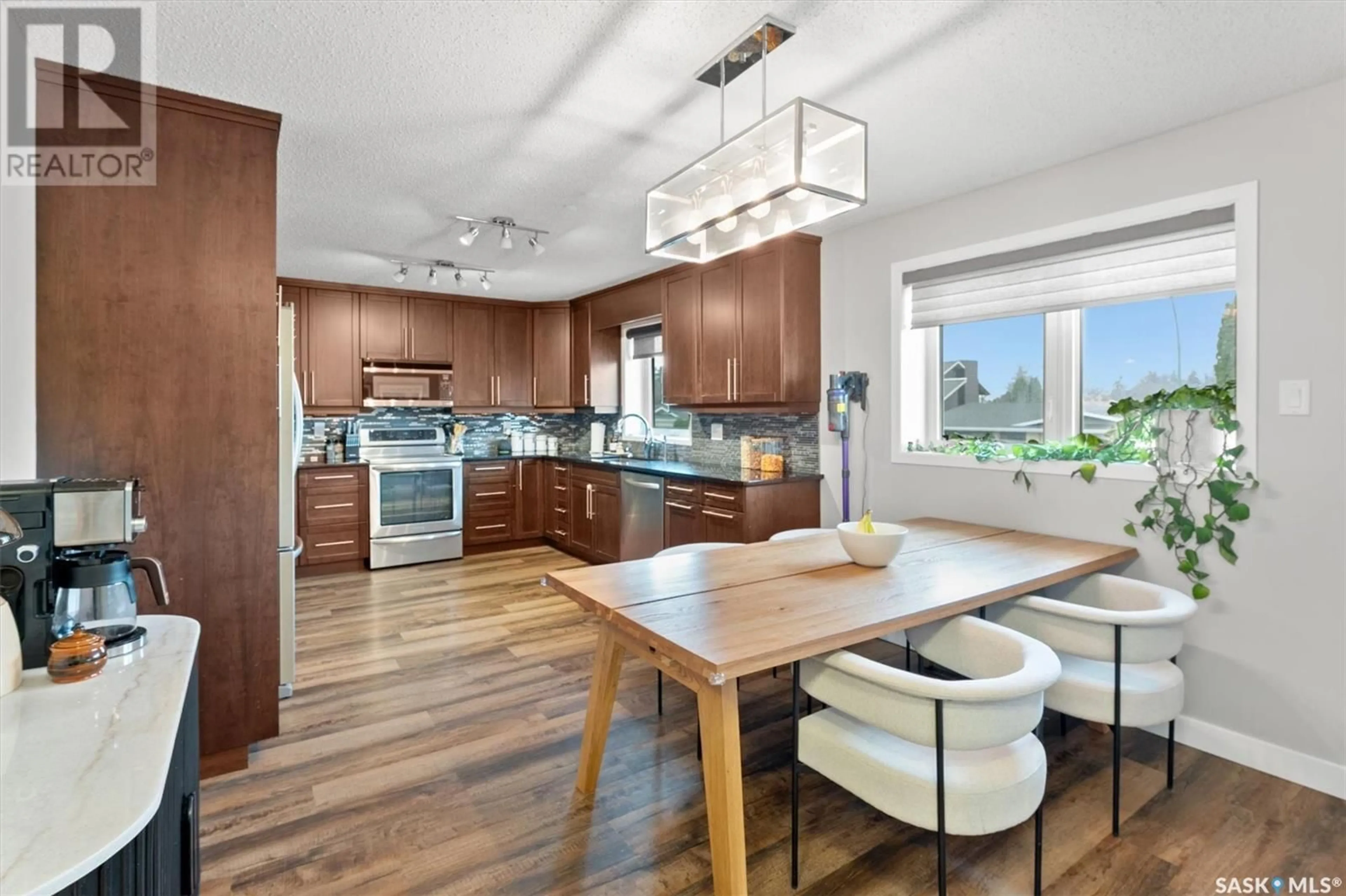 Open concept kitchen, wood/laminate floor for 547 CHRISTOPHER LANE, Saskatoon Saskatchewan S7J3S4