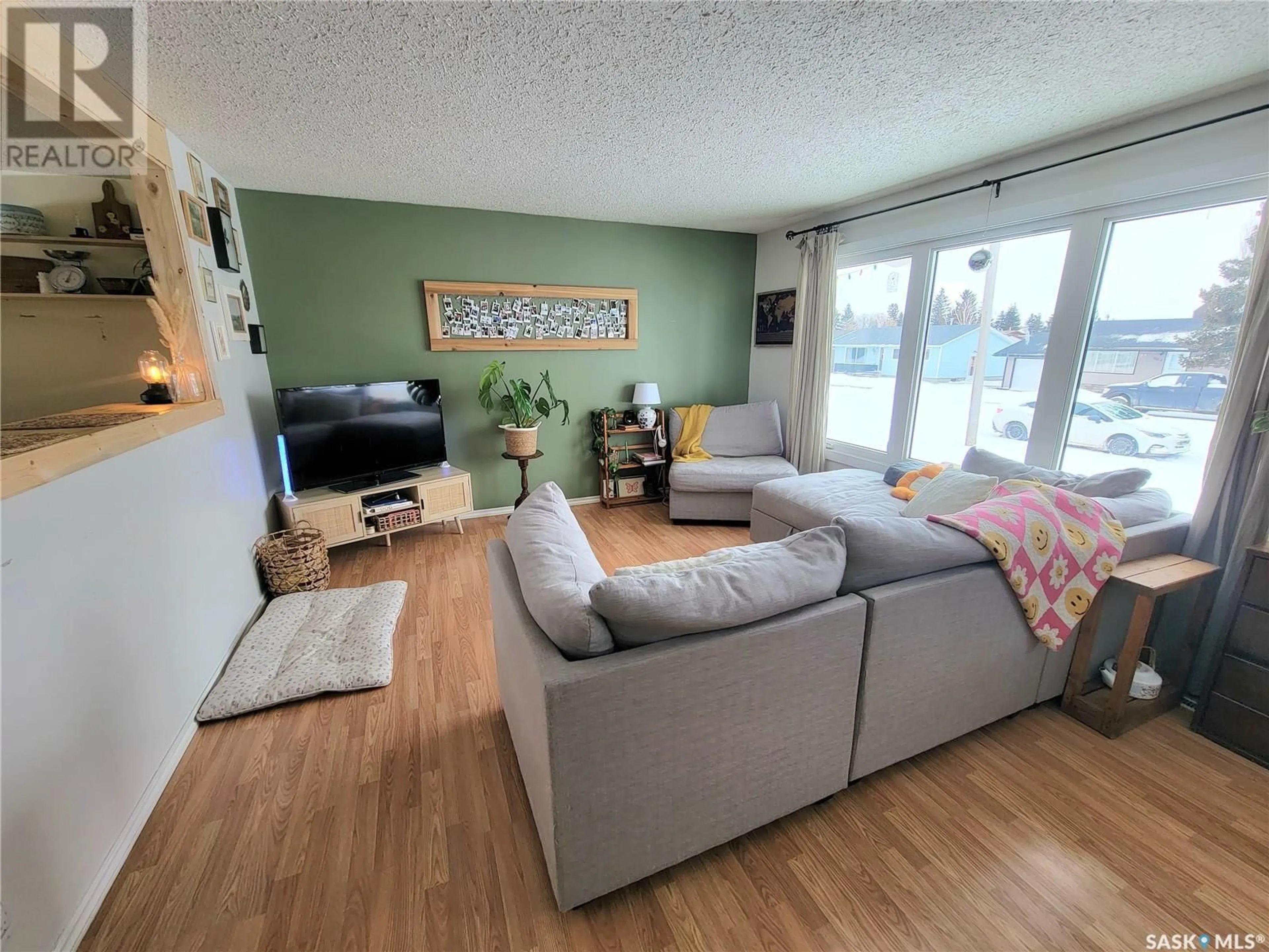 Living room with furniture, wood/laminate floor for 5107 LEADER STREET, Macklin Saskatchewan S0L2C0