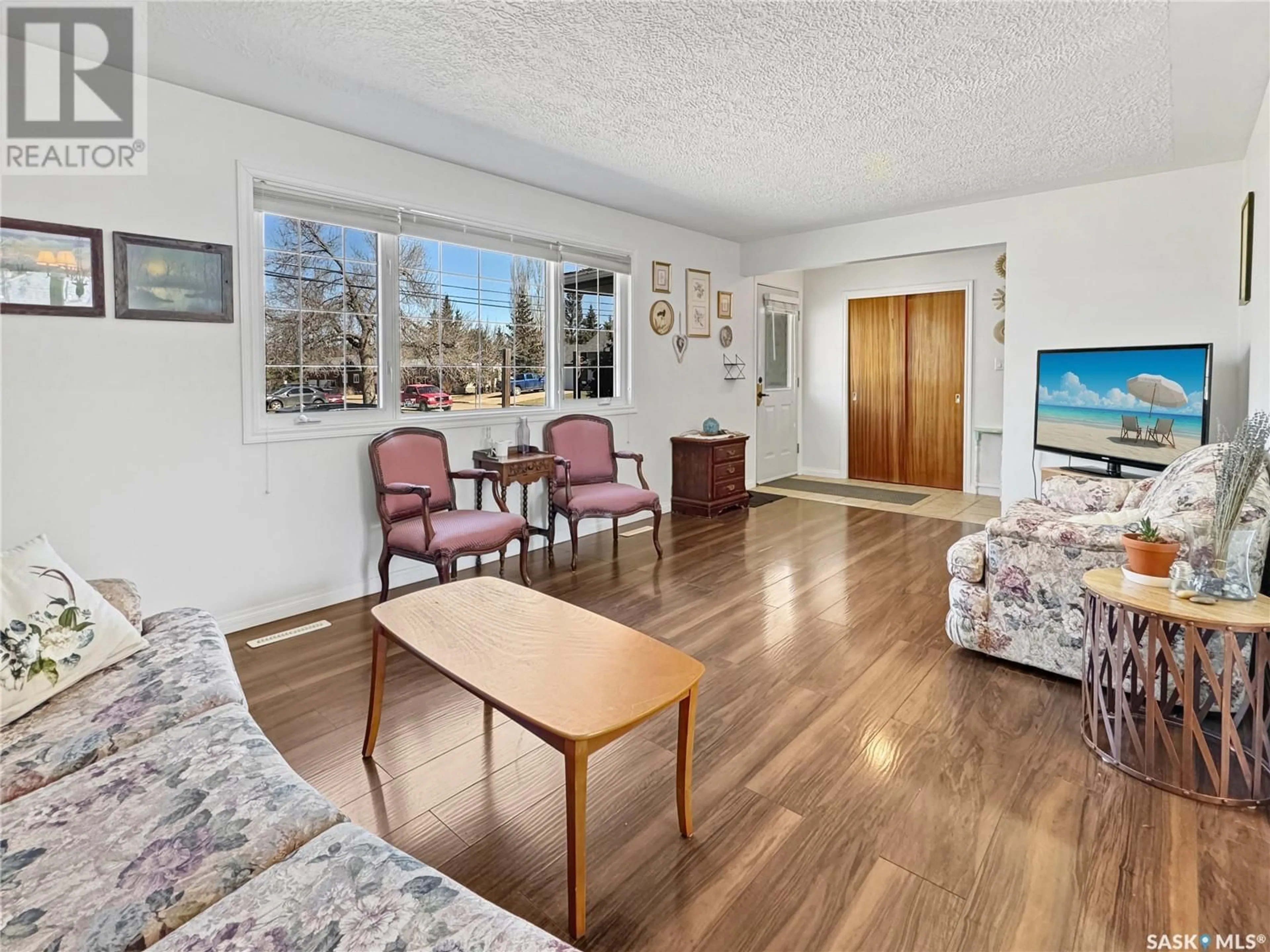 Living room with furniture, wood/laminate floor for 891 111TH STREET, North Battleford Saskatchewan S9A2J9
