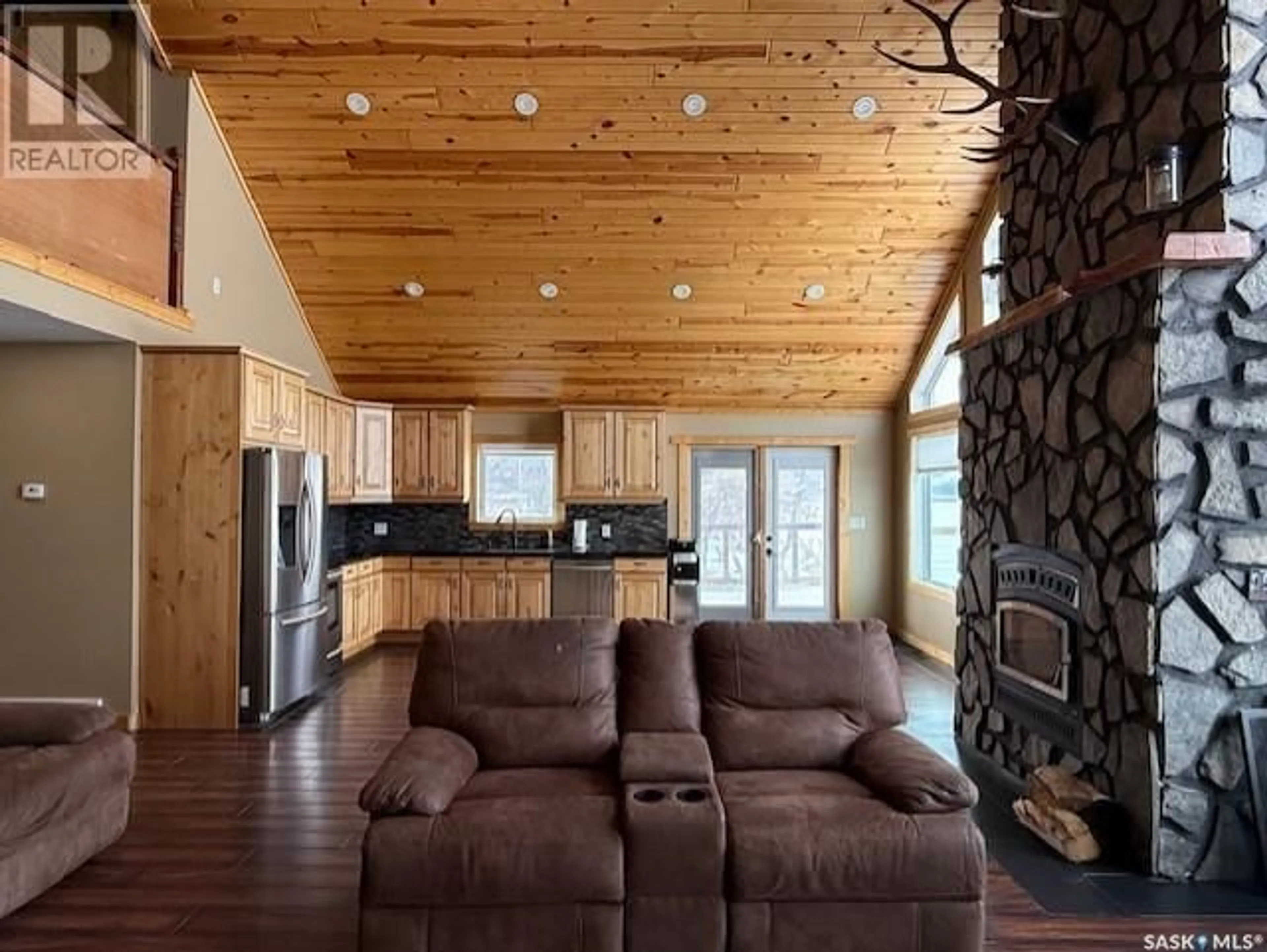 Living room with furniture, wood/laminate floor for 152 CRIDDLE AVENUE, Crooked Lake Saskatchewan S0G5L0