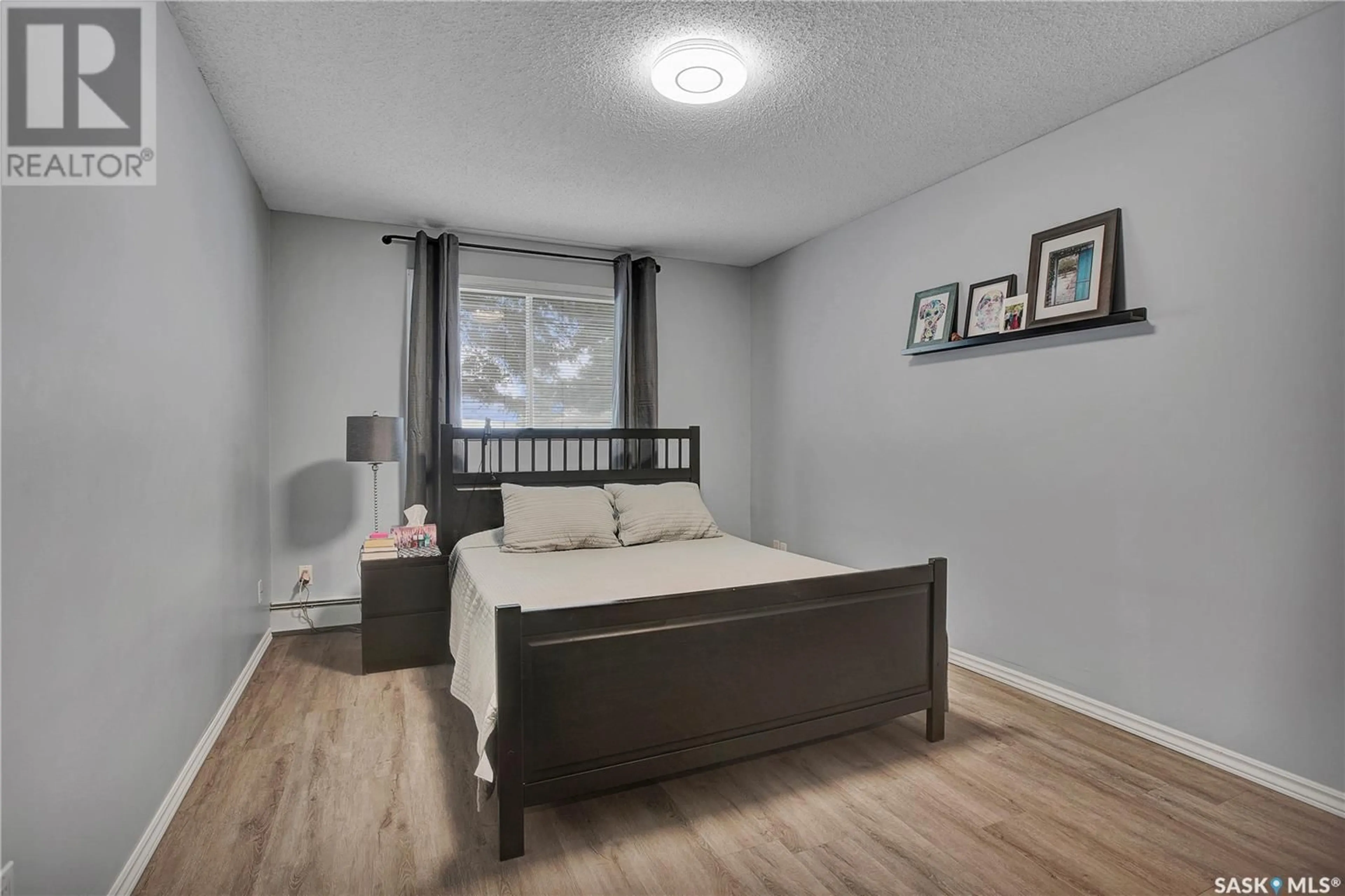 Bedroom with bed, wood/laminate floor for 706 - 107 CONFEDERATION DRIVE, Saskatoon Saskatchewan S7L5R7
