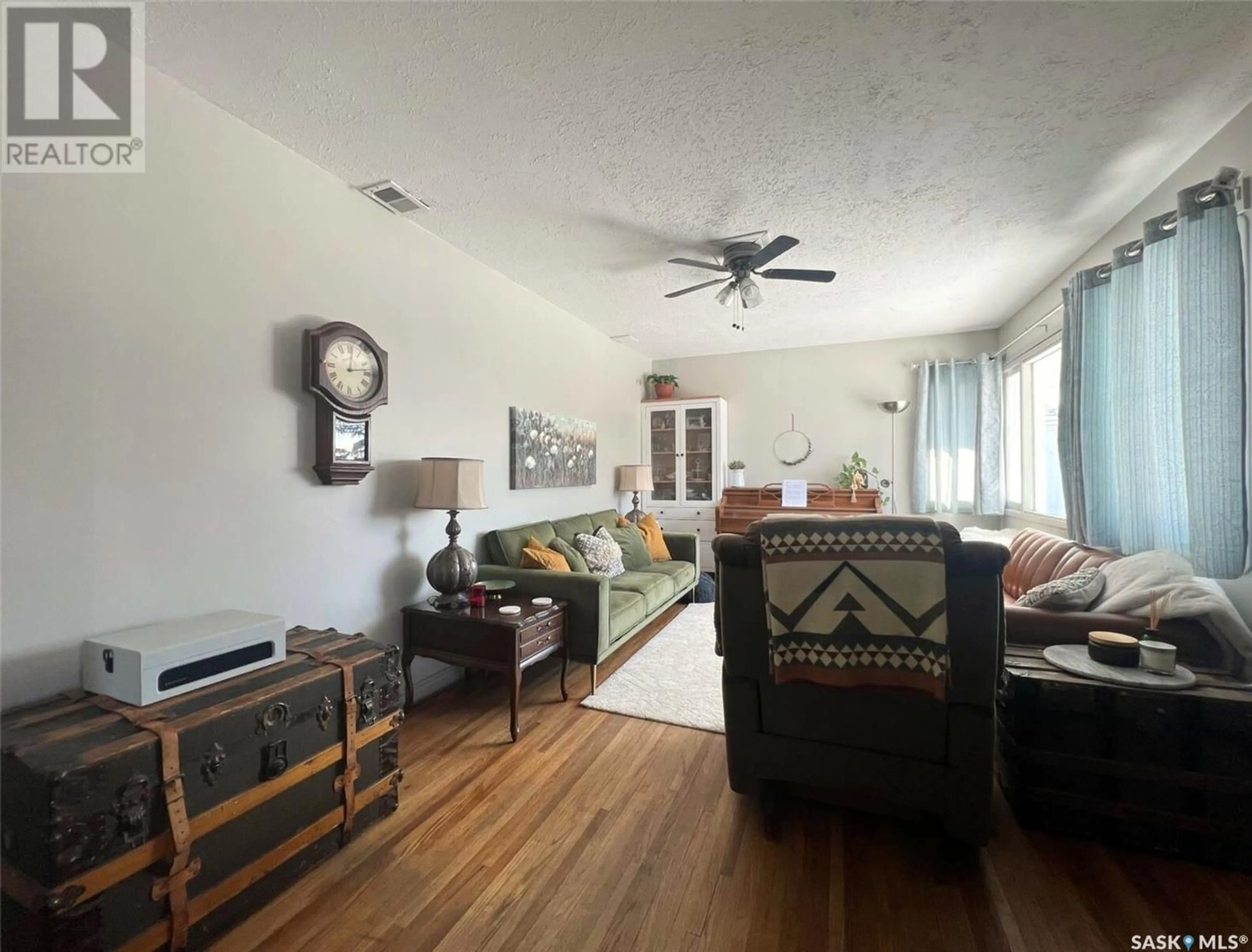 Living room with furniture, wood/laminate floor for 567 4TH AVENUE, Swift Current Saskatchewan S9H0V5
