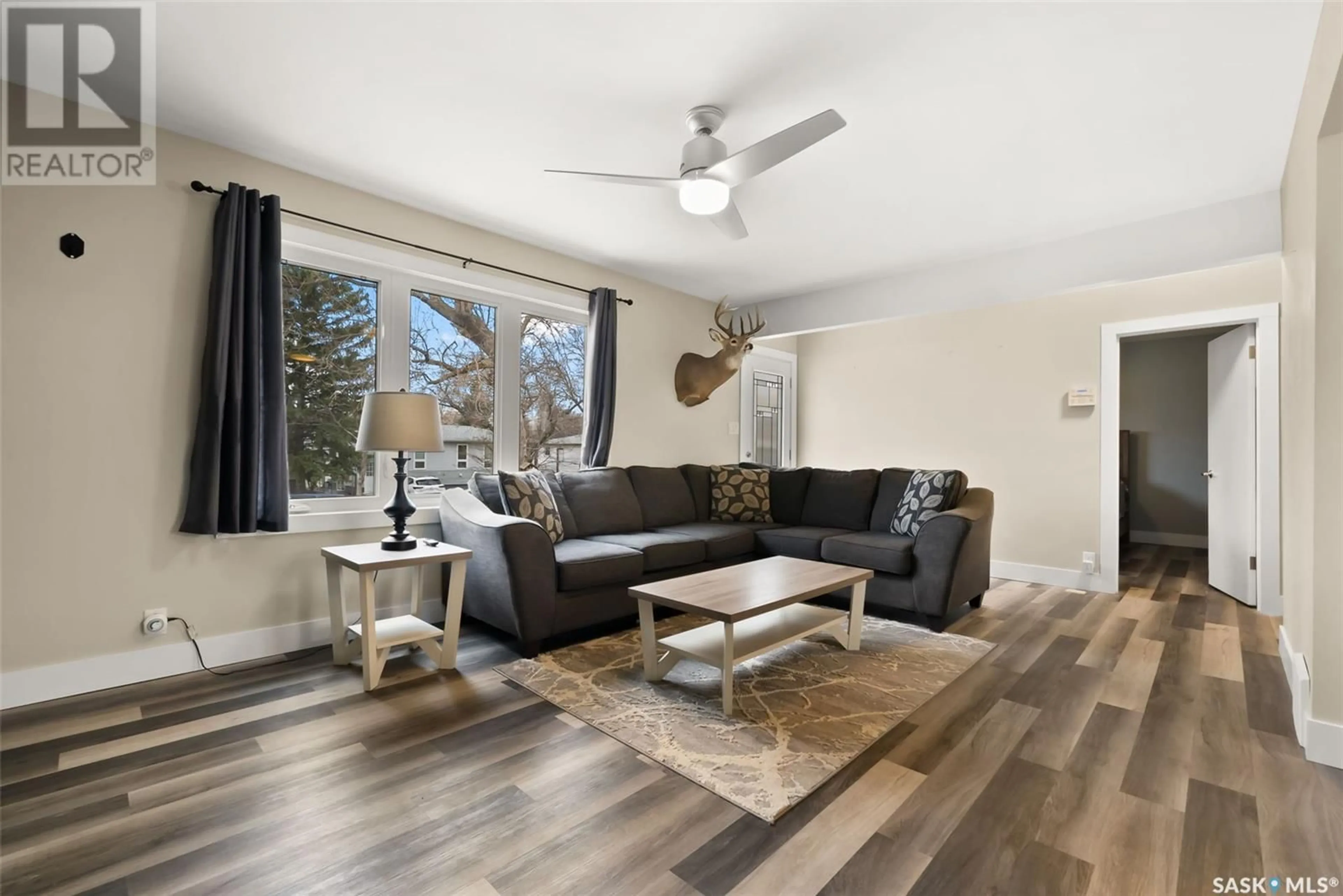 Living room with furniture, wood/laminate floor for 925 FORGET STREET, Regina Saskatchewan S4T4X7