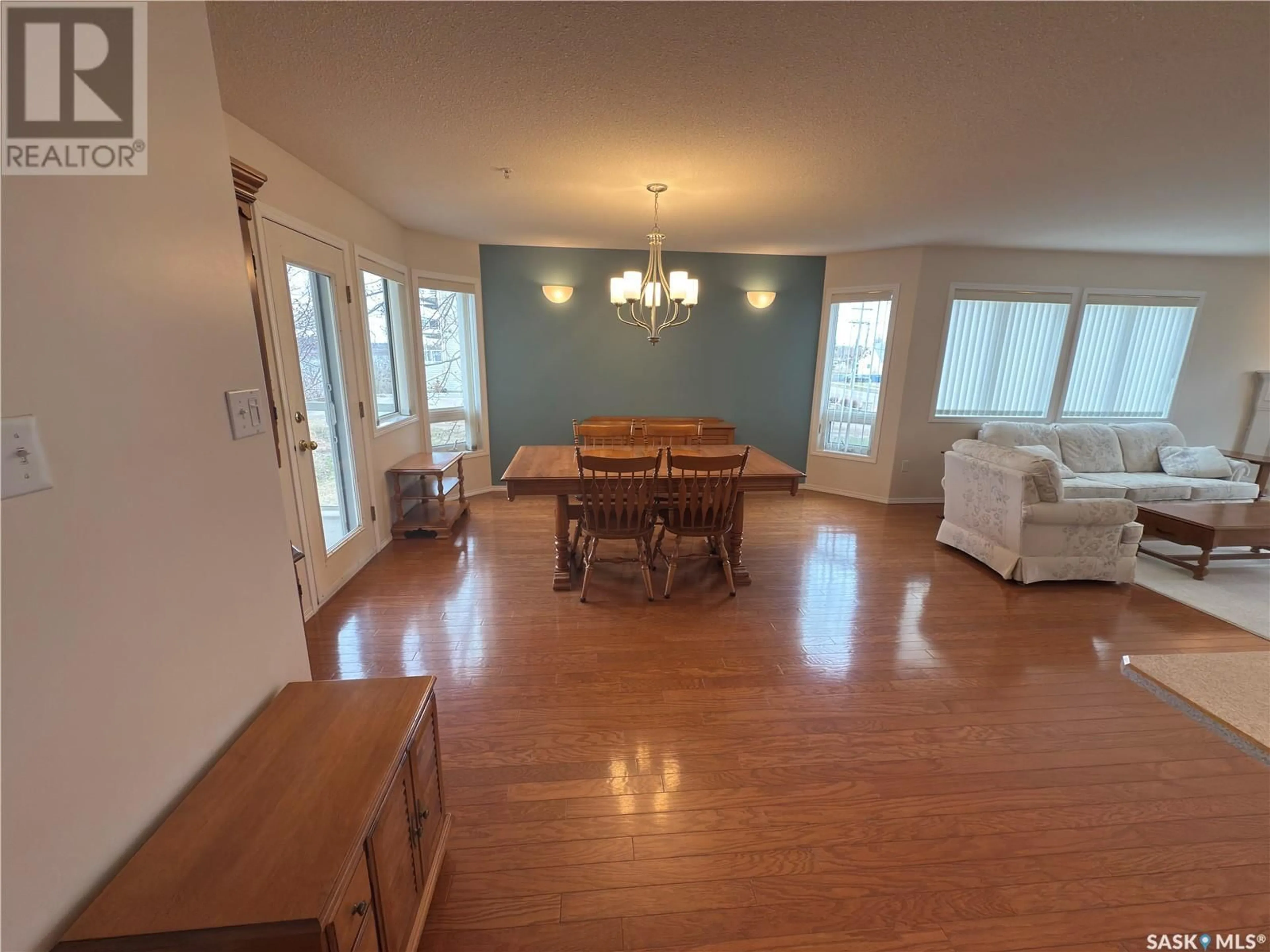 Living room with furniture, wood/laminate floor for 204 - 544 RIVER STREET, Prince Albert Saskatchewan S6V0A6