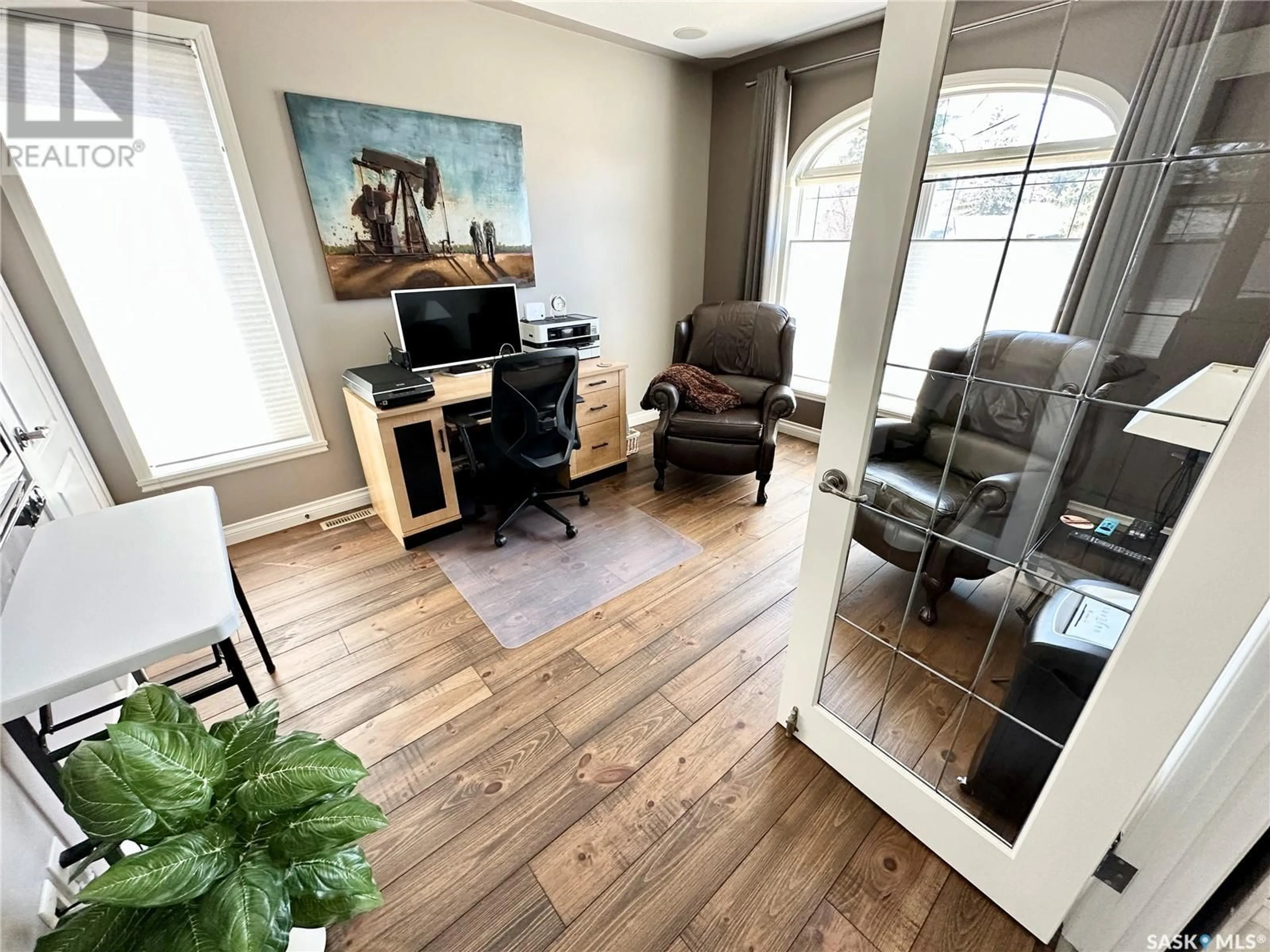 Living room with furniture, wood/laminate floor for 83 ASH DRIVE, Weyburn Saskatchewan S4H0R9