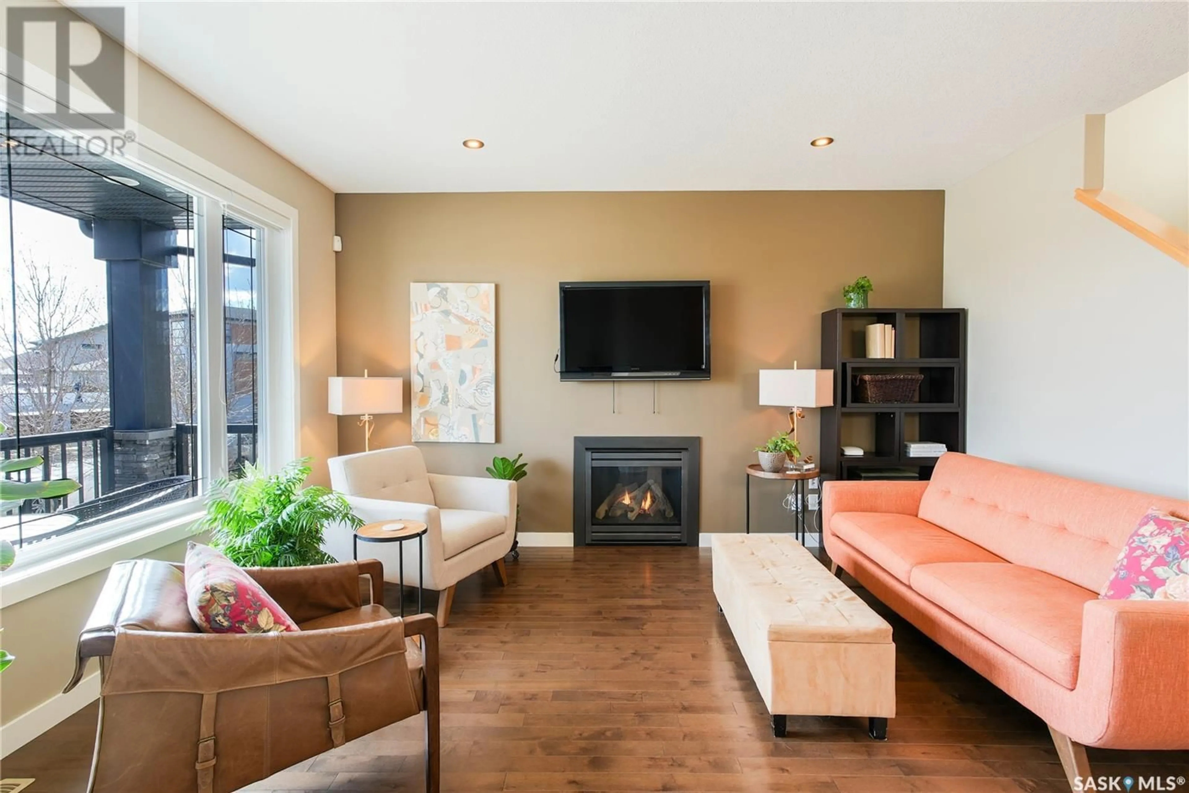 Living room with furniture, wood/laminate floor for 4665 JAMES HILL ROAD, Regina Saskatchewan S4W0C7