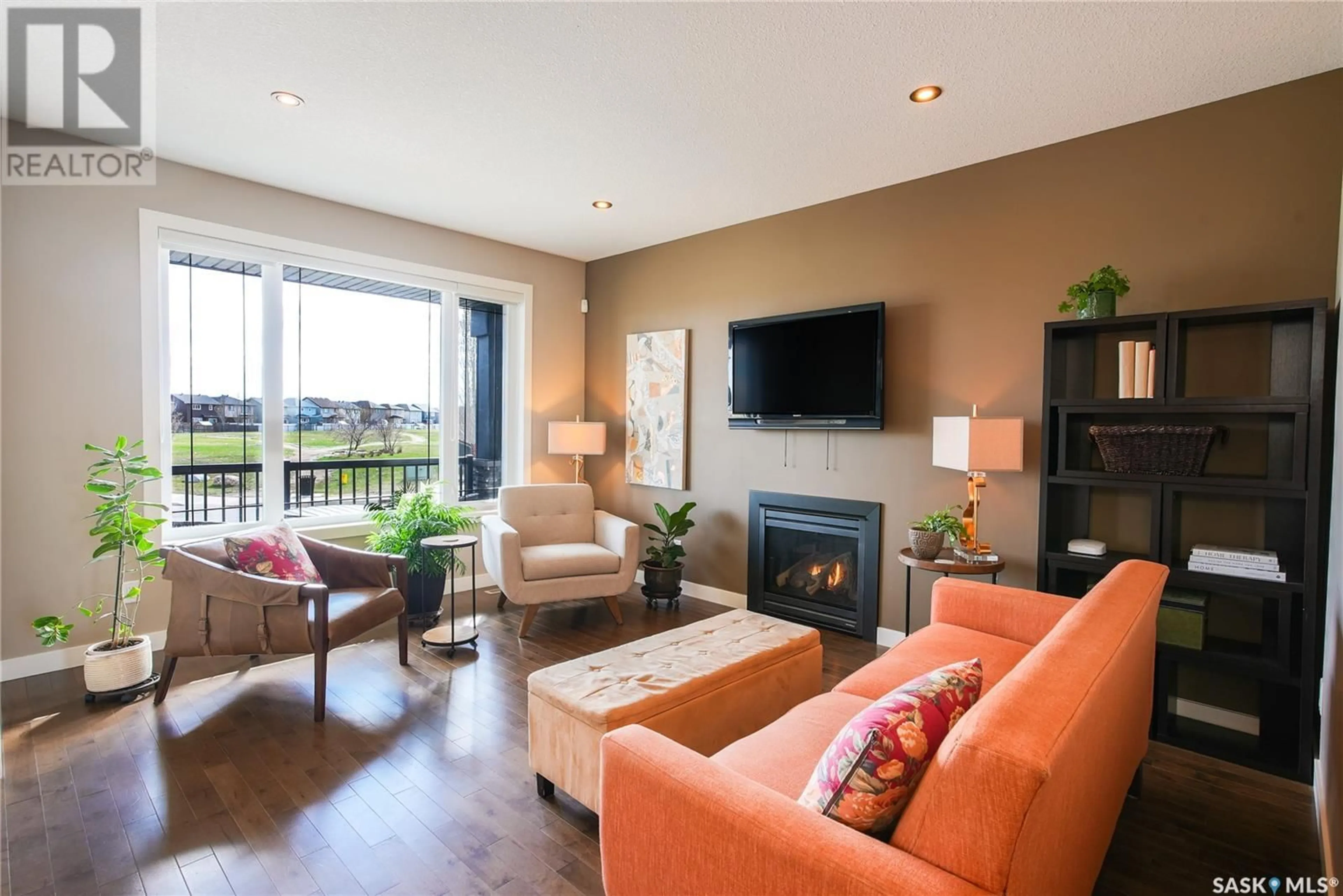 Living room with furniture, wood/laminate floor for 4665 JAMES HILL ROAD, Regina Saskatchewan S4W0C7