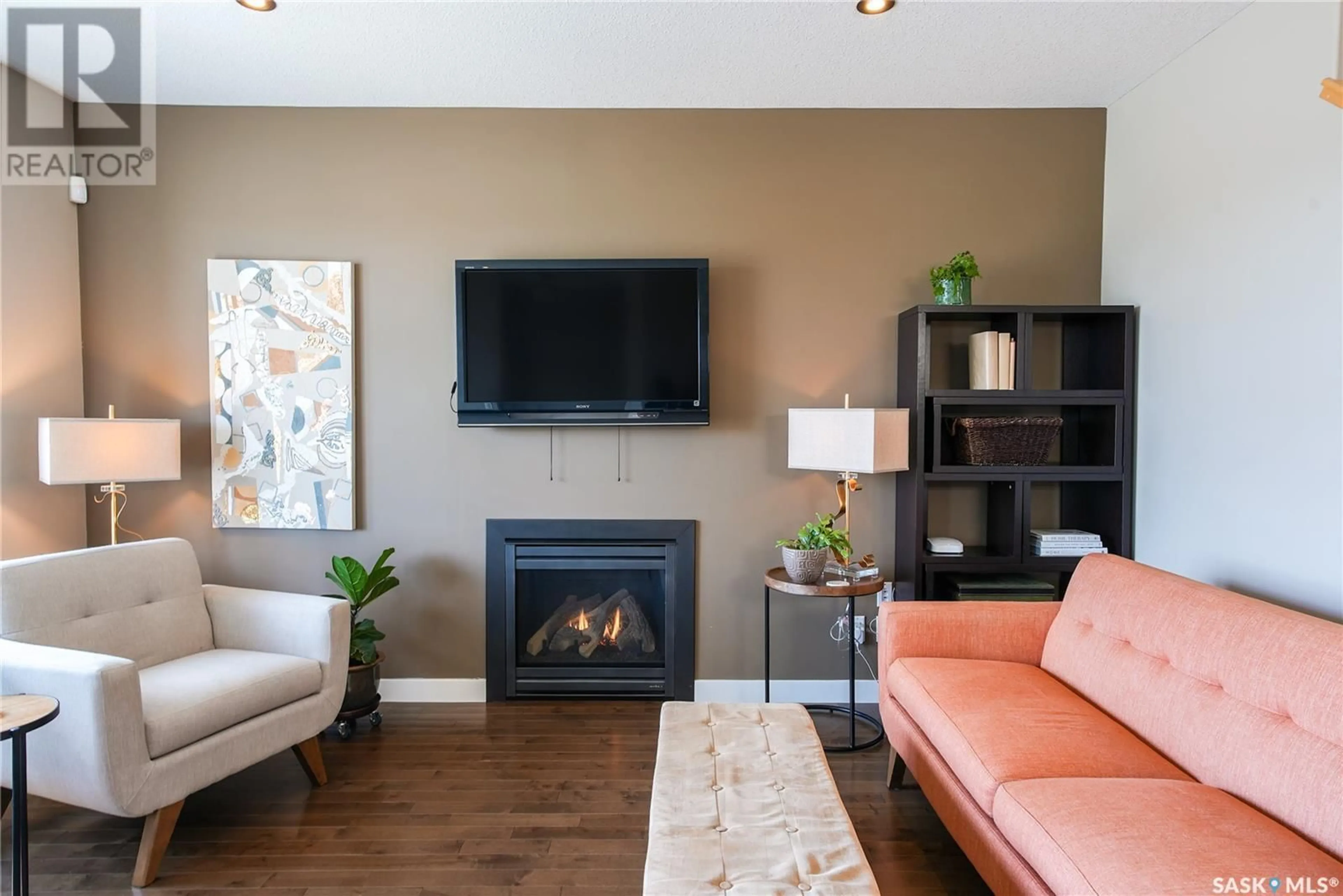 Living room with furniture, wood/laminate floor for 4665 JAMES HILL ROAD, Regina Saskatchewan S4W0C7