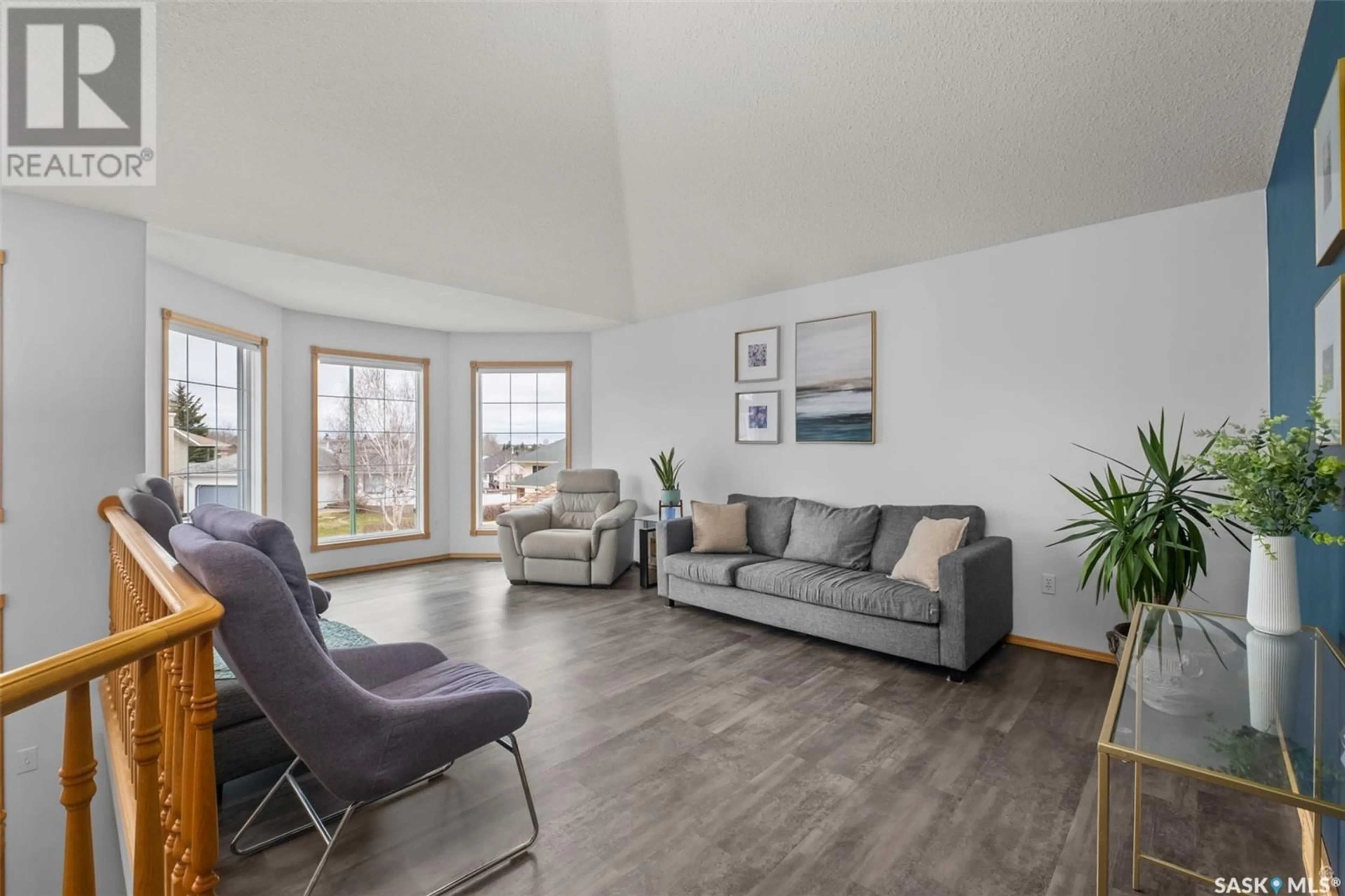 Living room with furniture, wood/laminate floor for 22 MCKNIGHT DRIVE, Prince Albert Saskatchewan S6V7Z7
