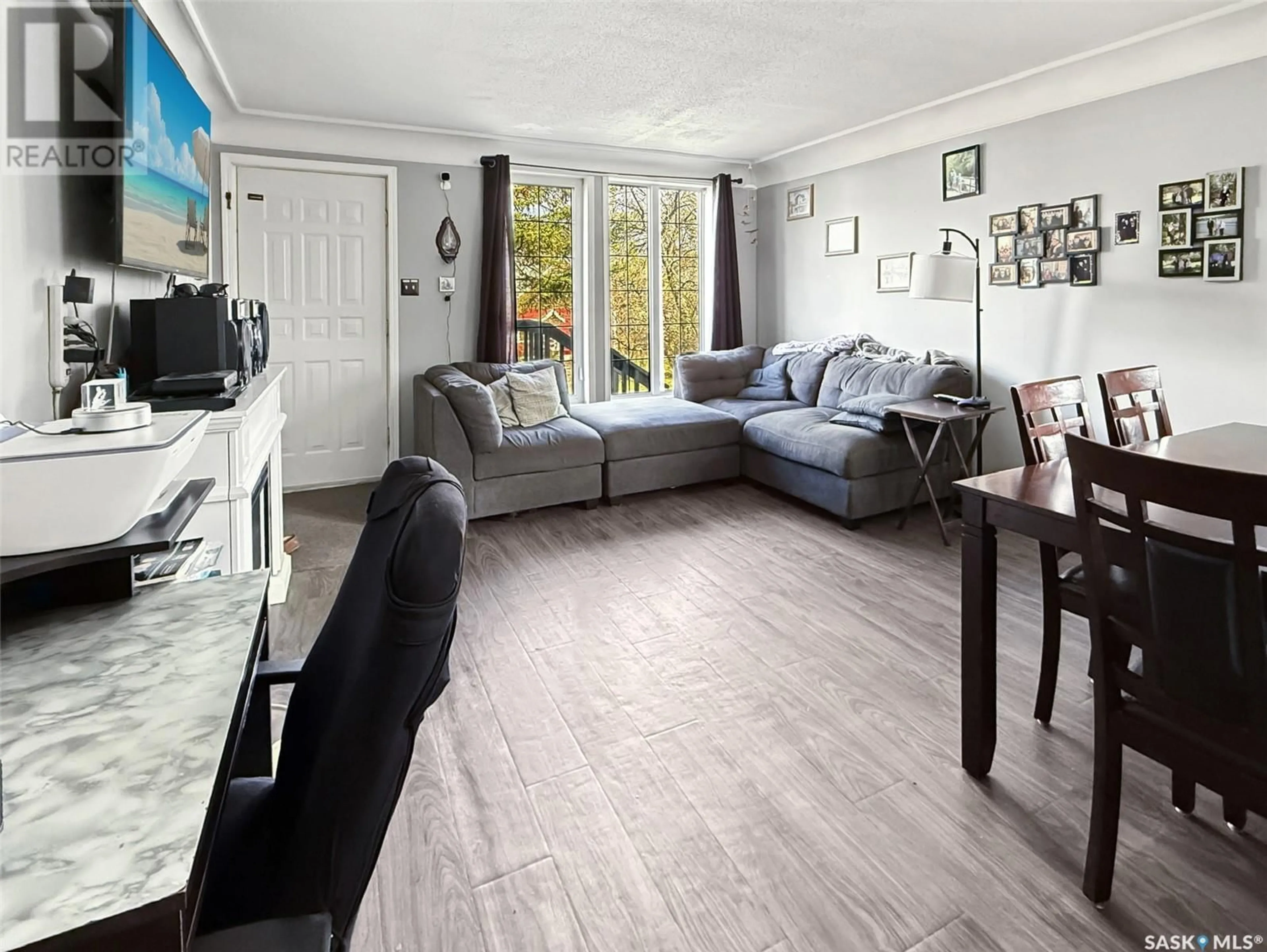 Living room with furniture, wood/laminate floor for 520 CENTRAL AVENUE, Swift Current Saskatchewan S9H0L9