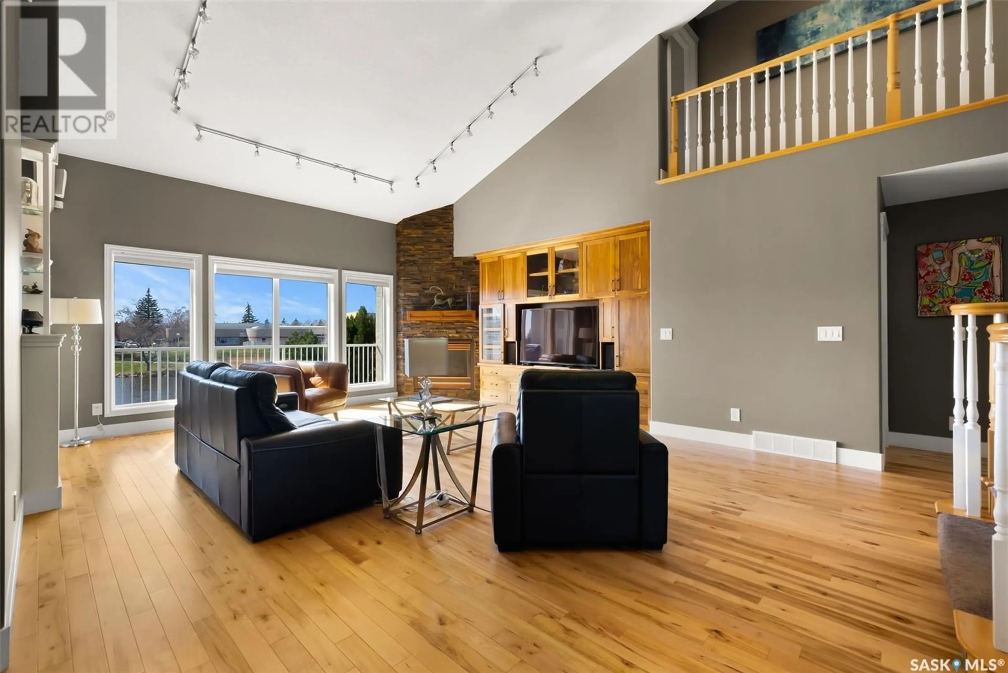 Living room with furniture, wood/laminate floor for 3208 WINCHESTER ROAD, Regina Saskatchewan S4V2T4