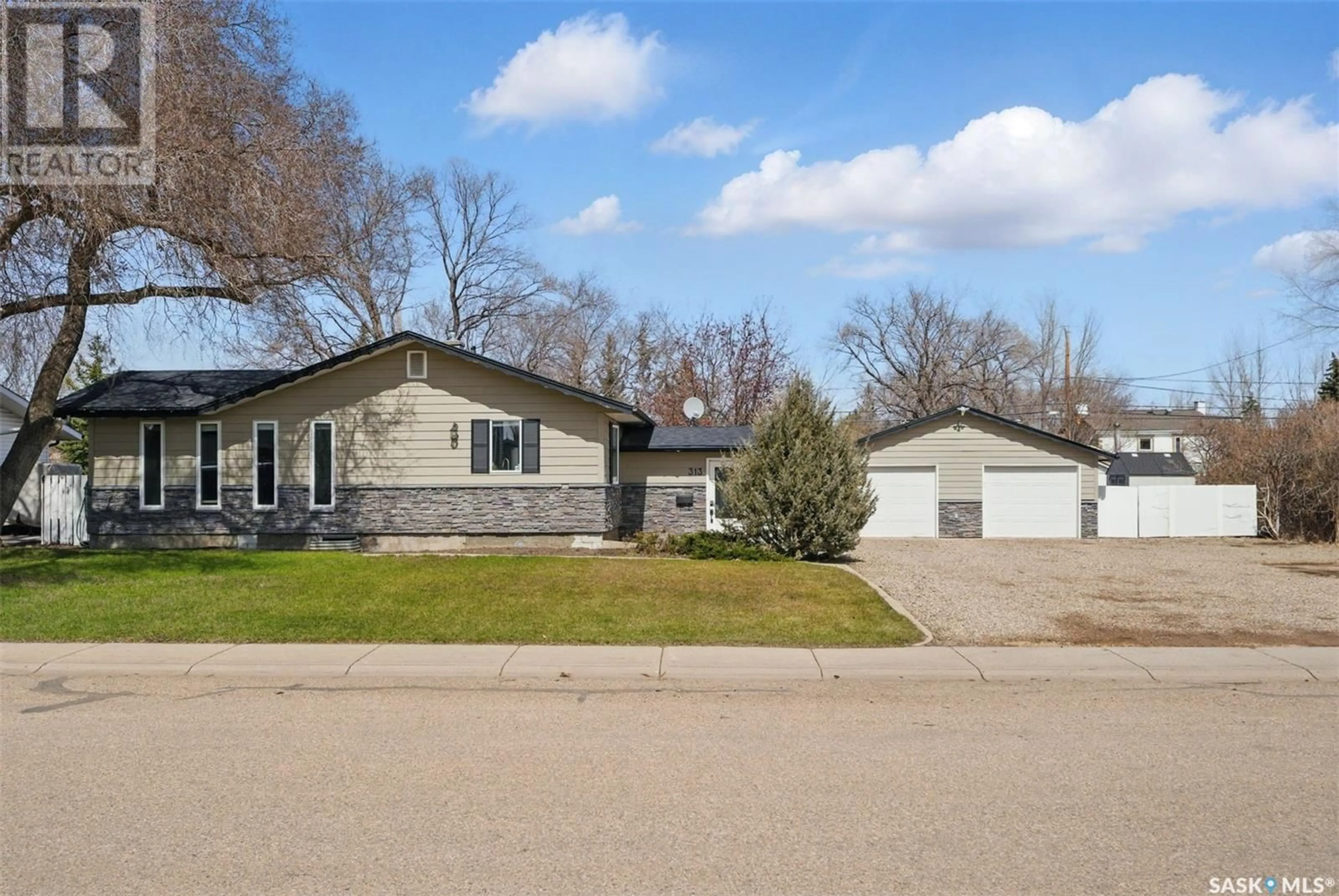 Home with vinyl exterior material, street for 313 3RD STREET, Martensville Saskatchewan S0K0A2