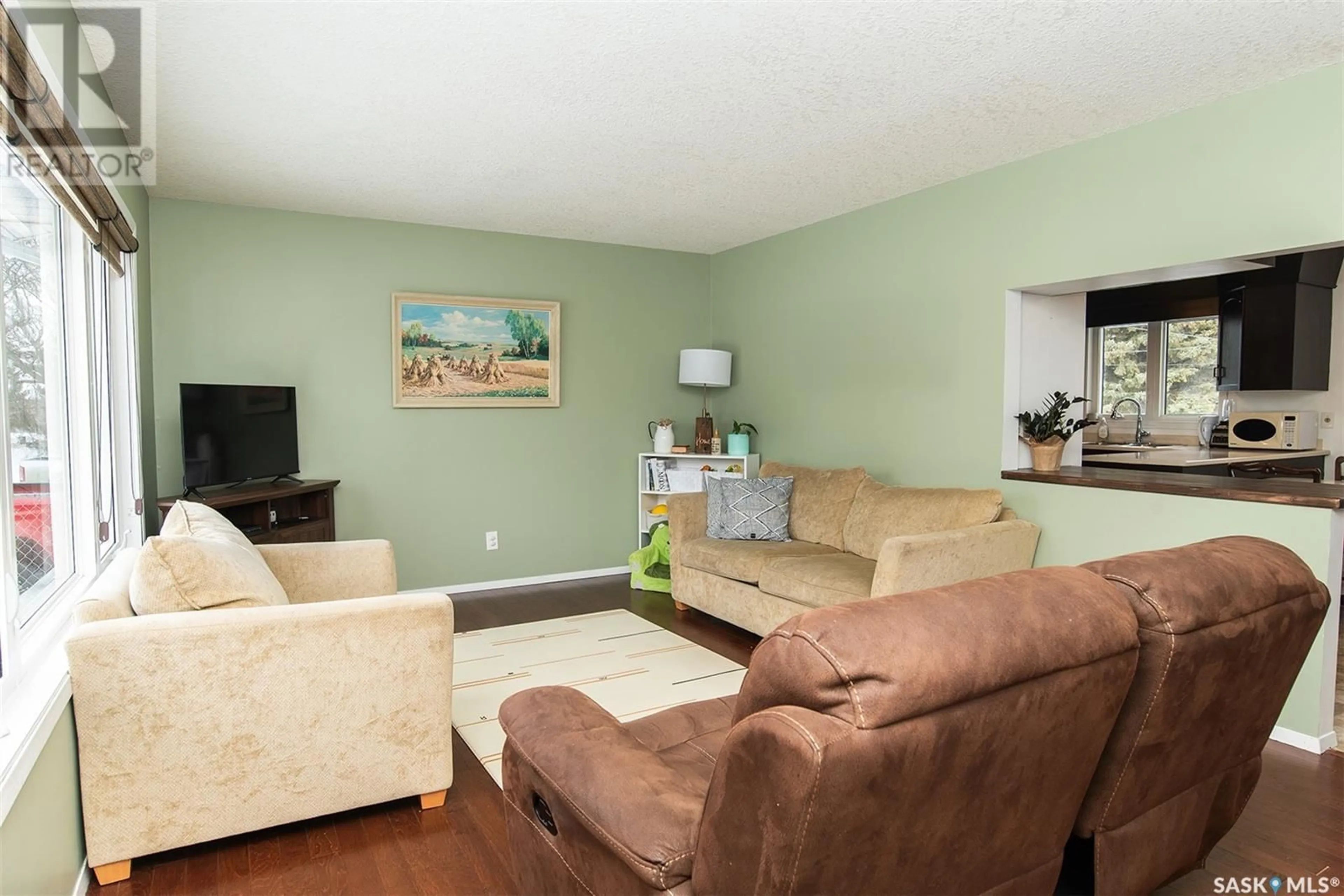 Living room with furniture, wood/laminate floor for 512 4TH STREET, Wynyard Saskatchewan S0A4T0