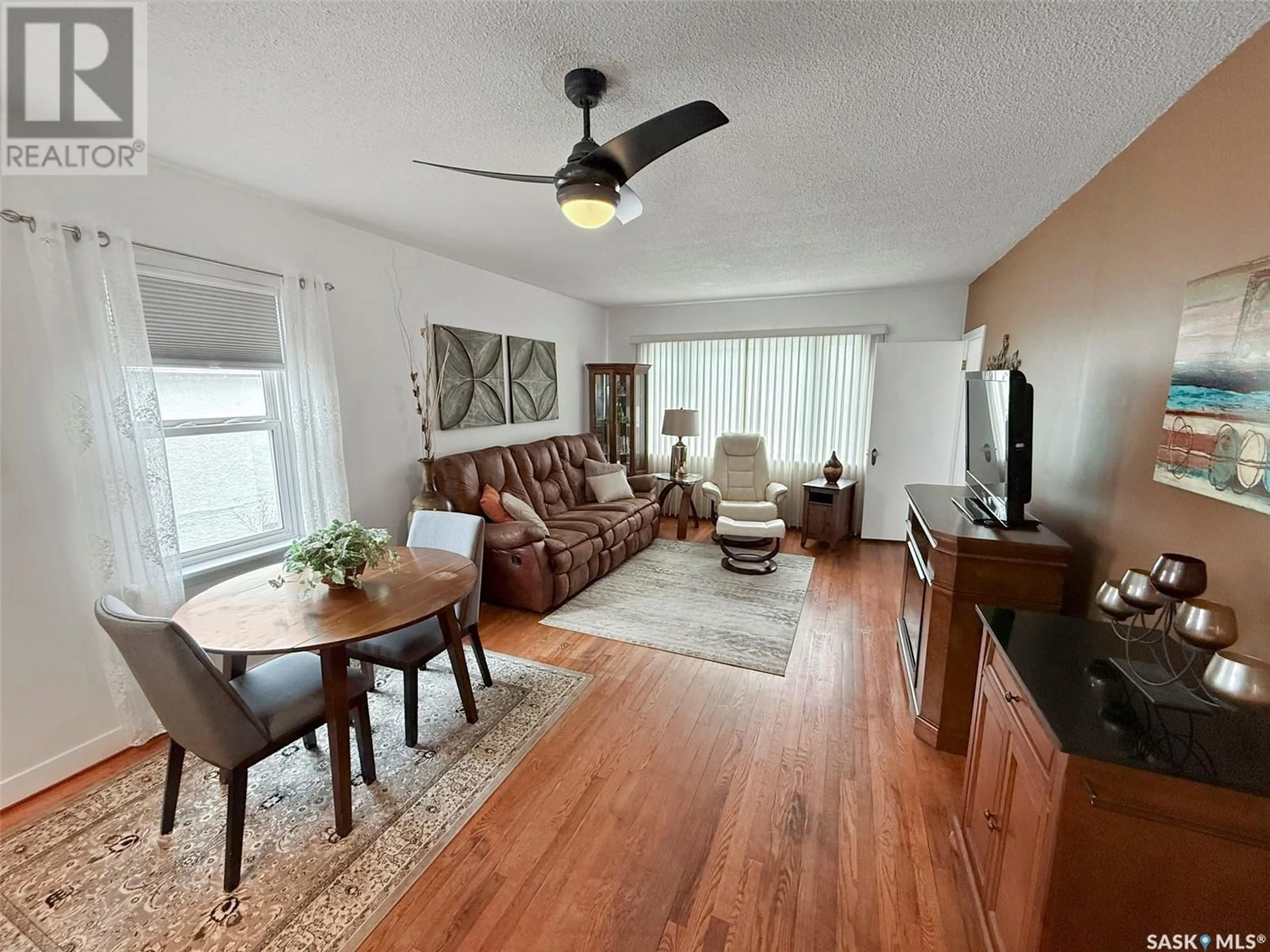 Living room with furniture, wood/laminate floor for 543 CENTRAL AVENUE, Swift Current Saskatchewan S9H0L8