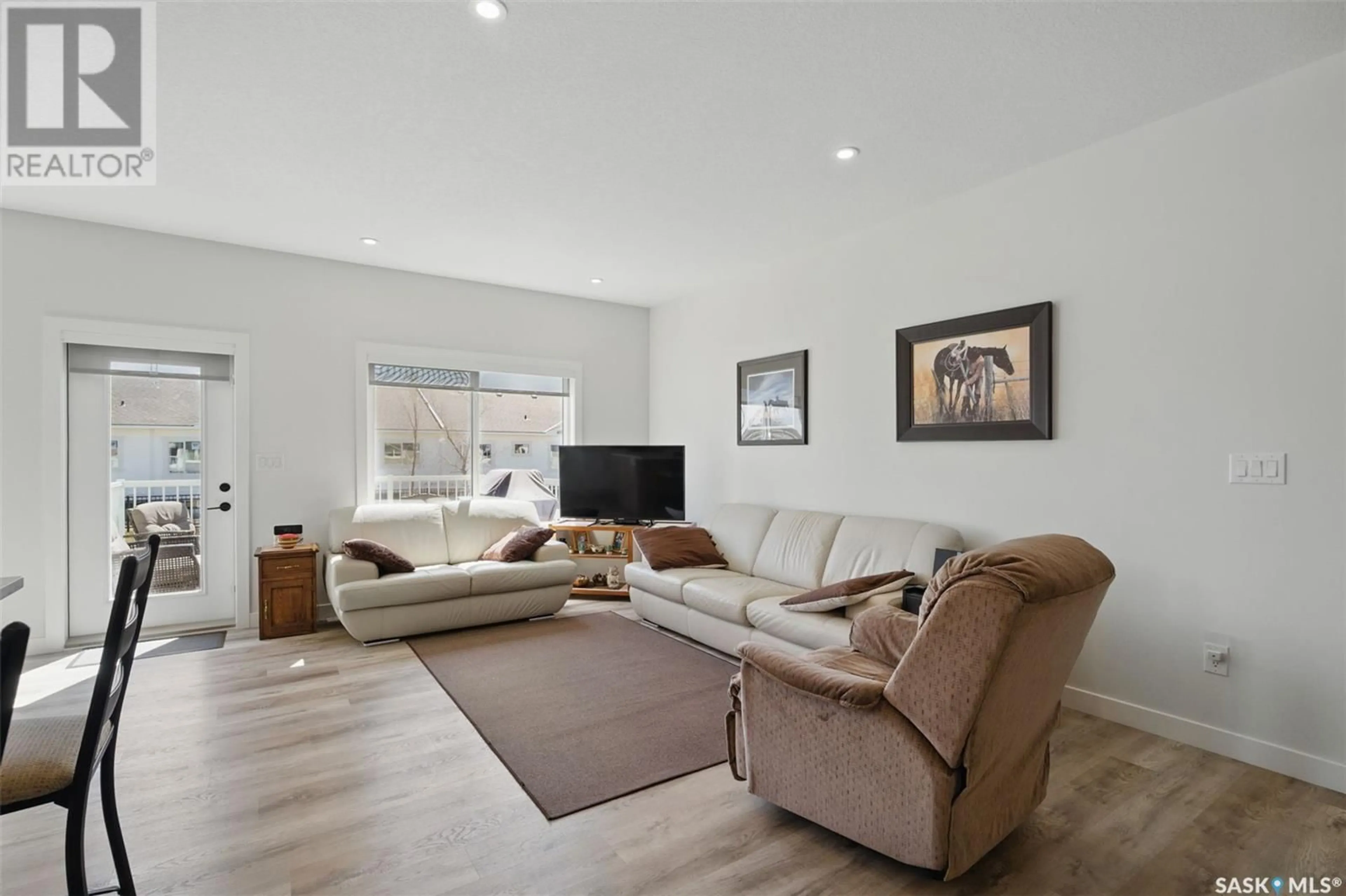 Living room with furniture, wood/laminate floor for 202 170 MIROND ROAD, Martensville Saskatchewan S0K2T1