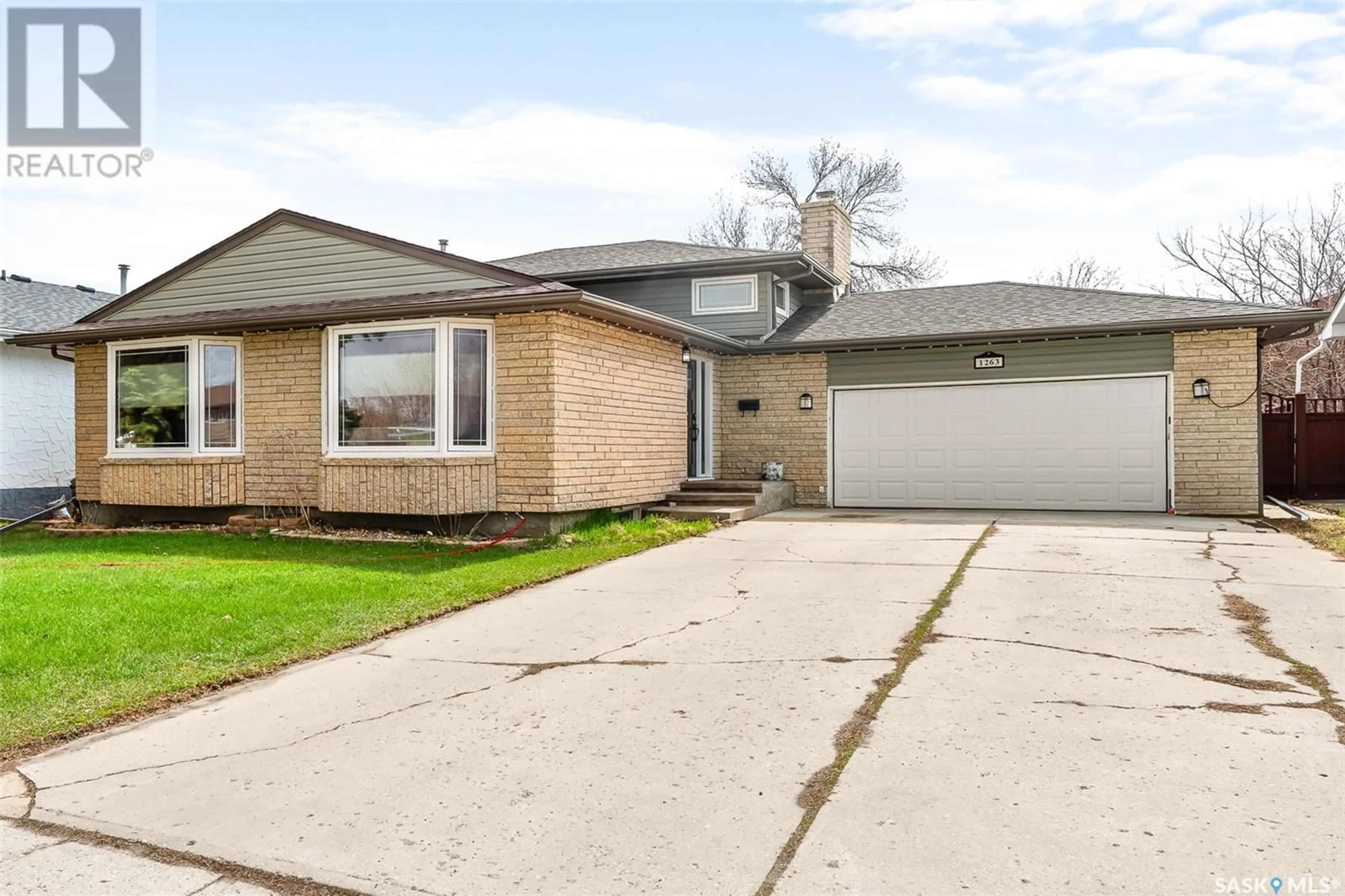 Home with brick exterior material, street for 1263 PASCOE DRIVE, Moose Jaw Saskatchewan S6H7H1