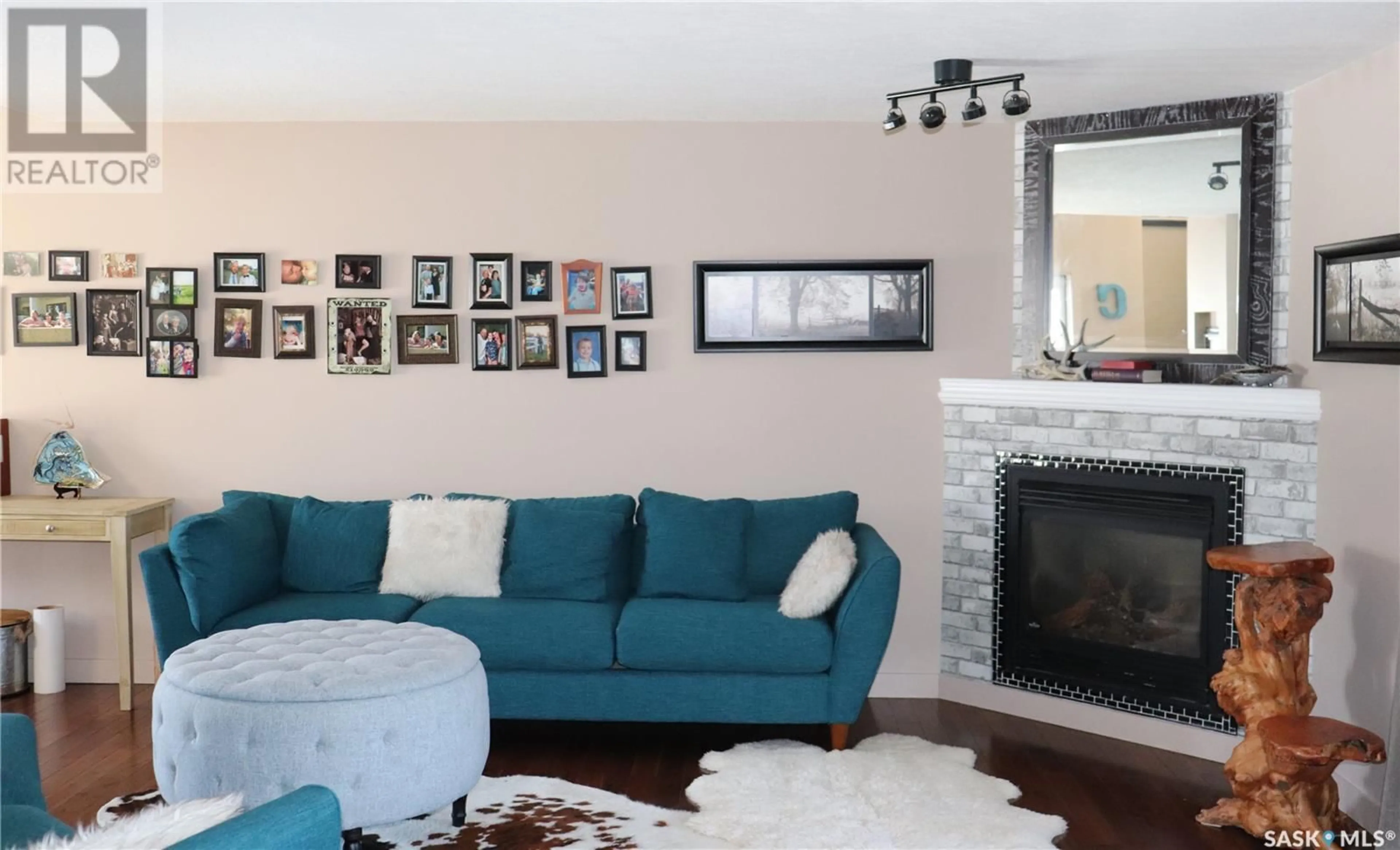Living room with furniture, wood/laminate floor for 106 2ND AVENUE, Lucky Lake Saskatchewan S0L1Z0