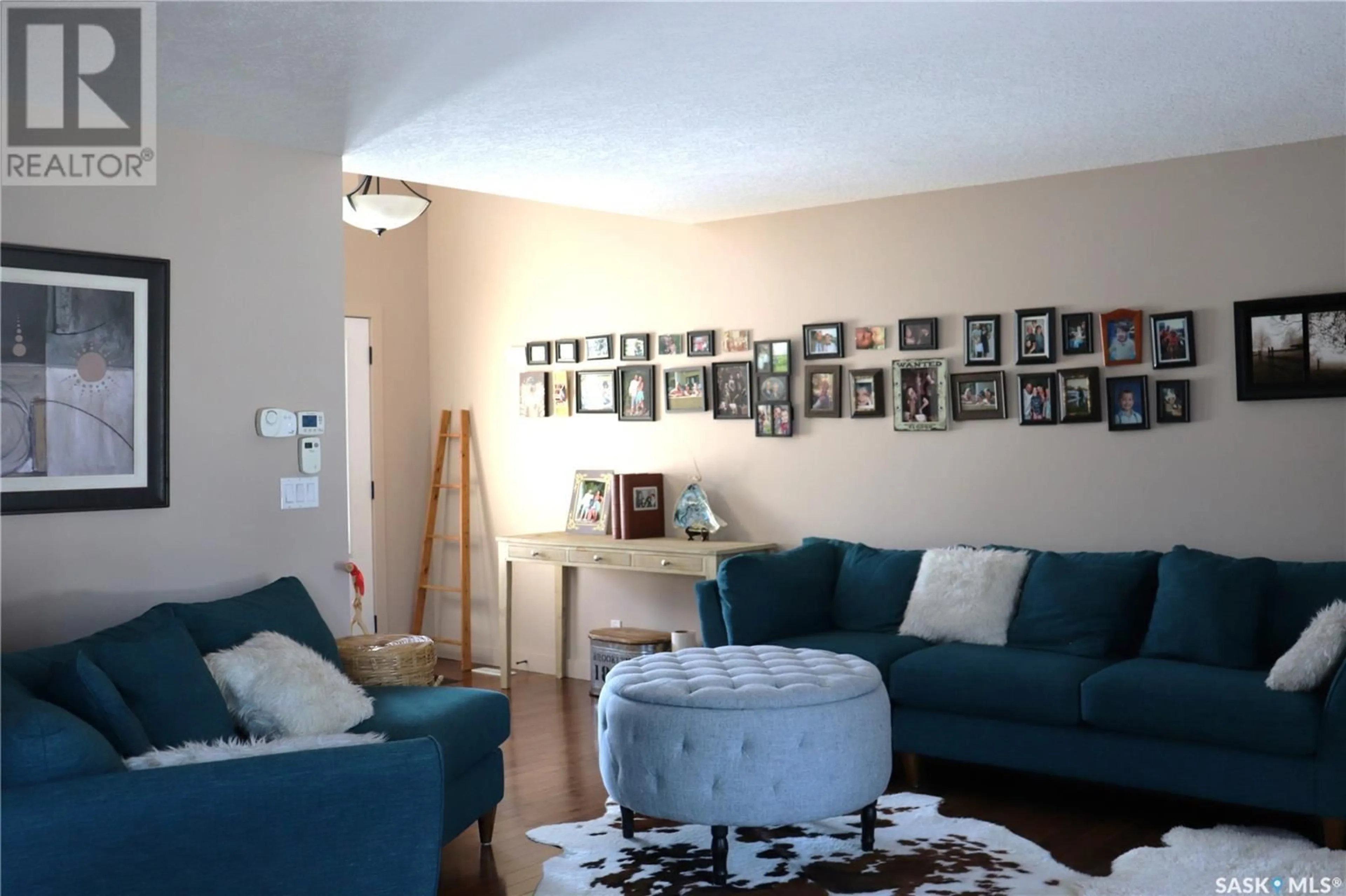 Living room with furniture, wood/laminate floor for 106 2ND AVENUE, Lucky Lake Saskatchewan S0L1Z0
