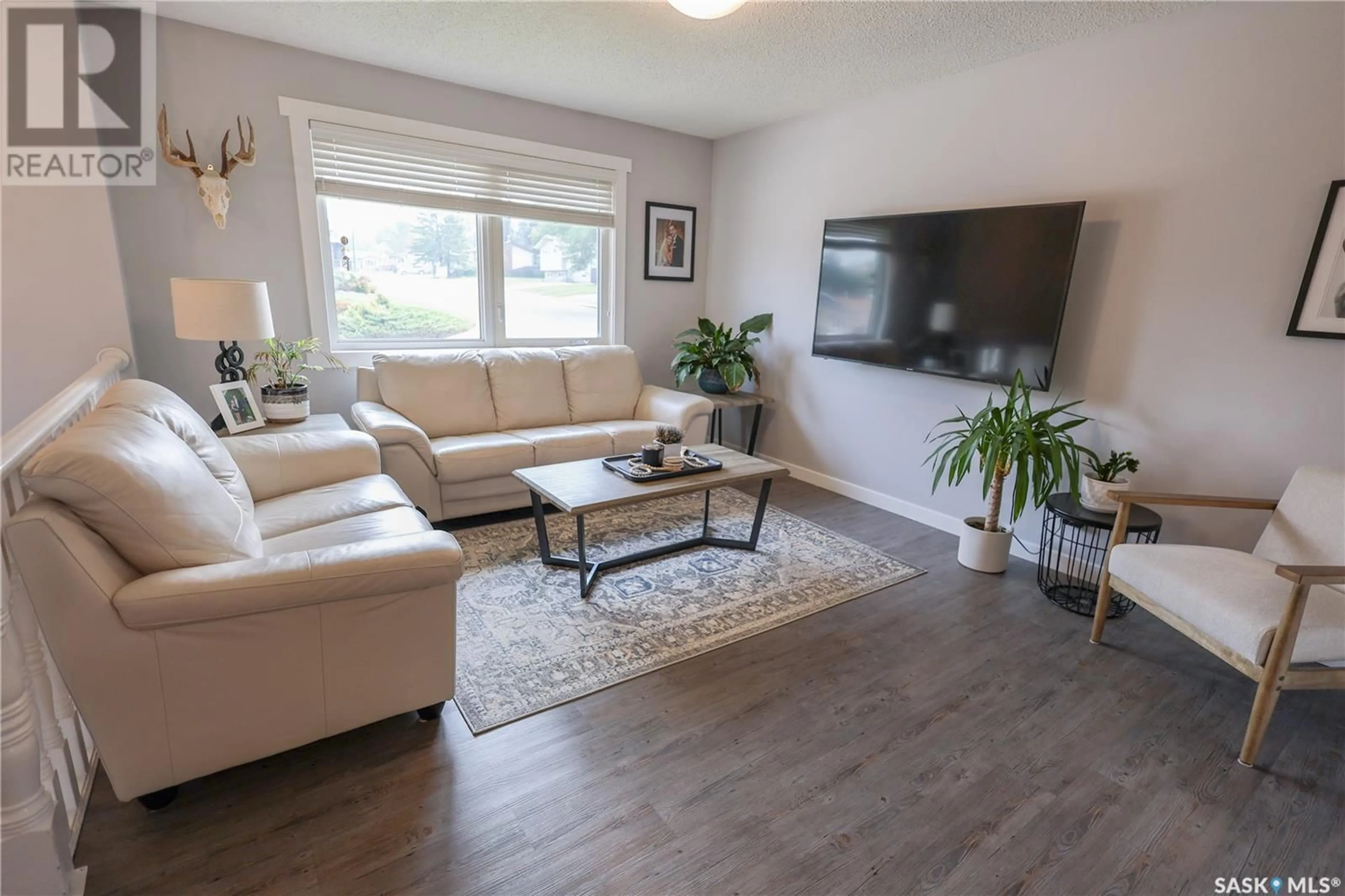 Living room with furniture, wood/laminate floor for 723 MCCRANEY CRESCENT, Prince Albert Saskatchewan S6V6W3