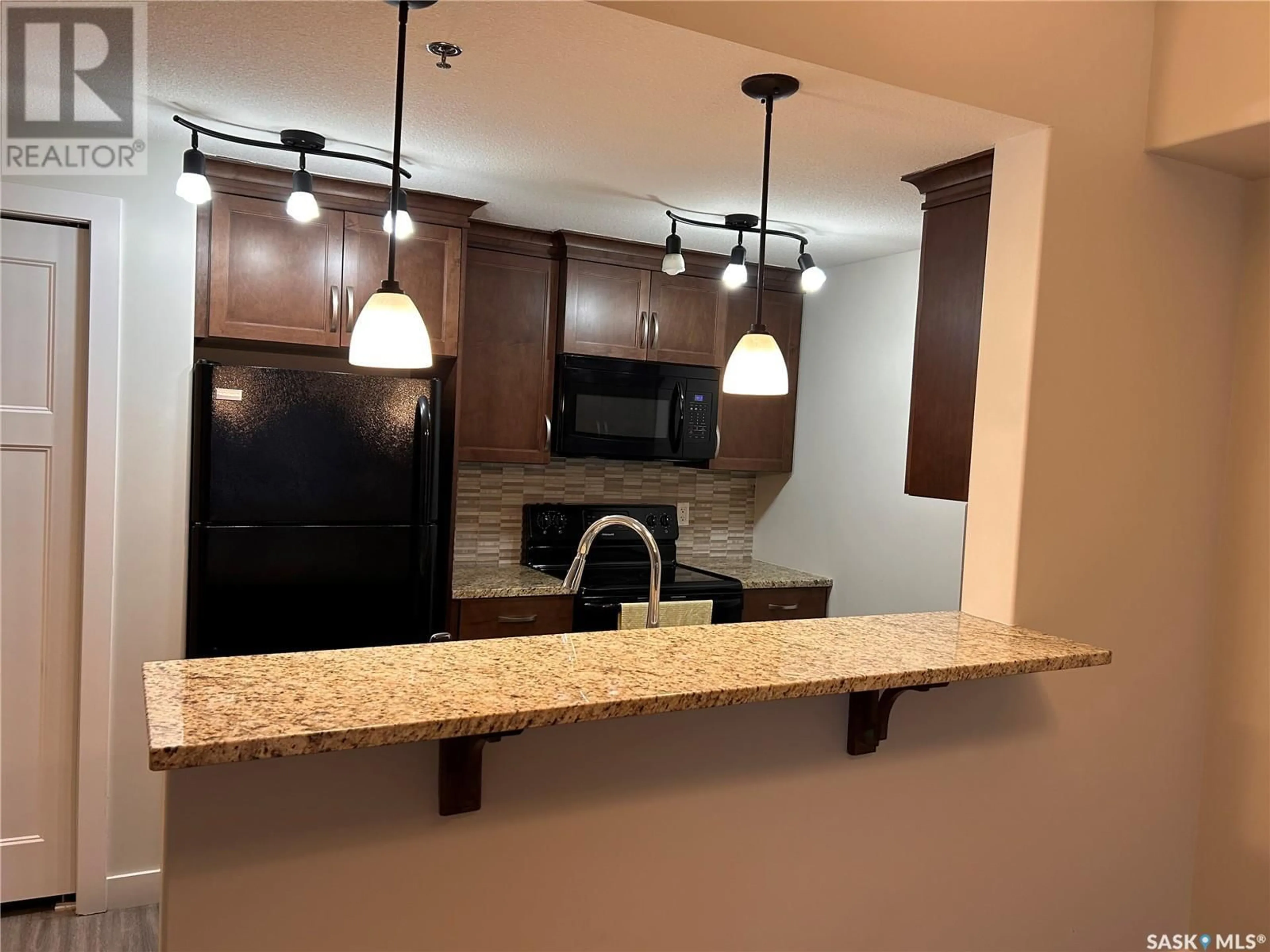Open concept kitchen, ceramic/tile floor for 102 - 1220 BLACKFOOT DRIVE, Regina Saskatchewan S4S6T2