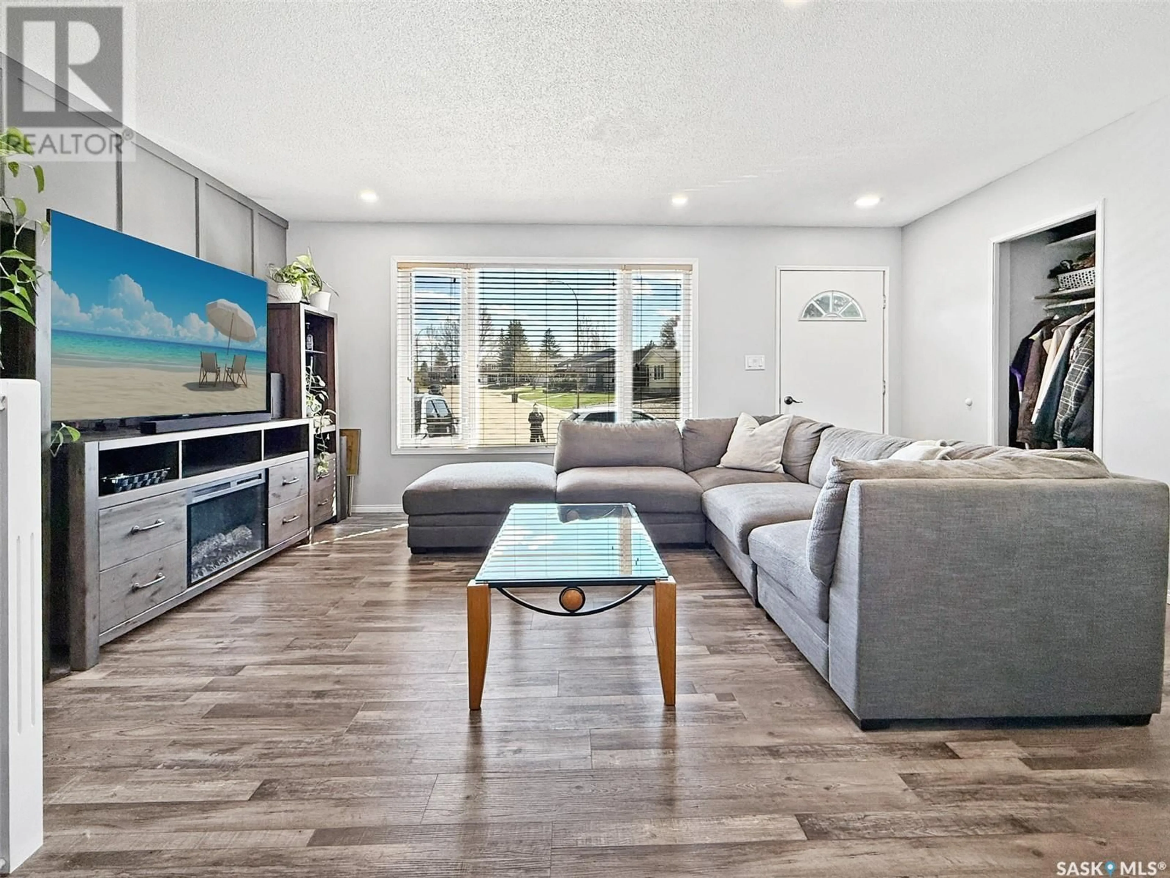 Living room with furniture, wood/laminate floor for 487 STEELE CRESCENT, Swift Current Saskatchewan S9H4P8