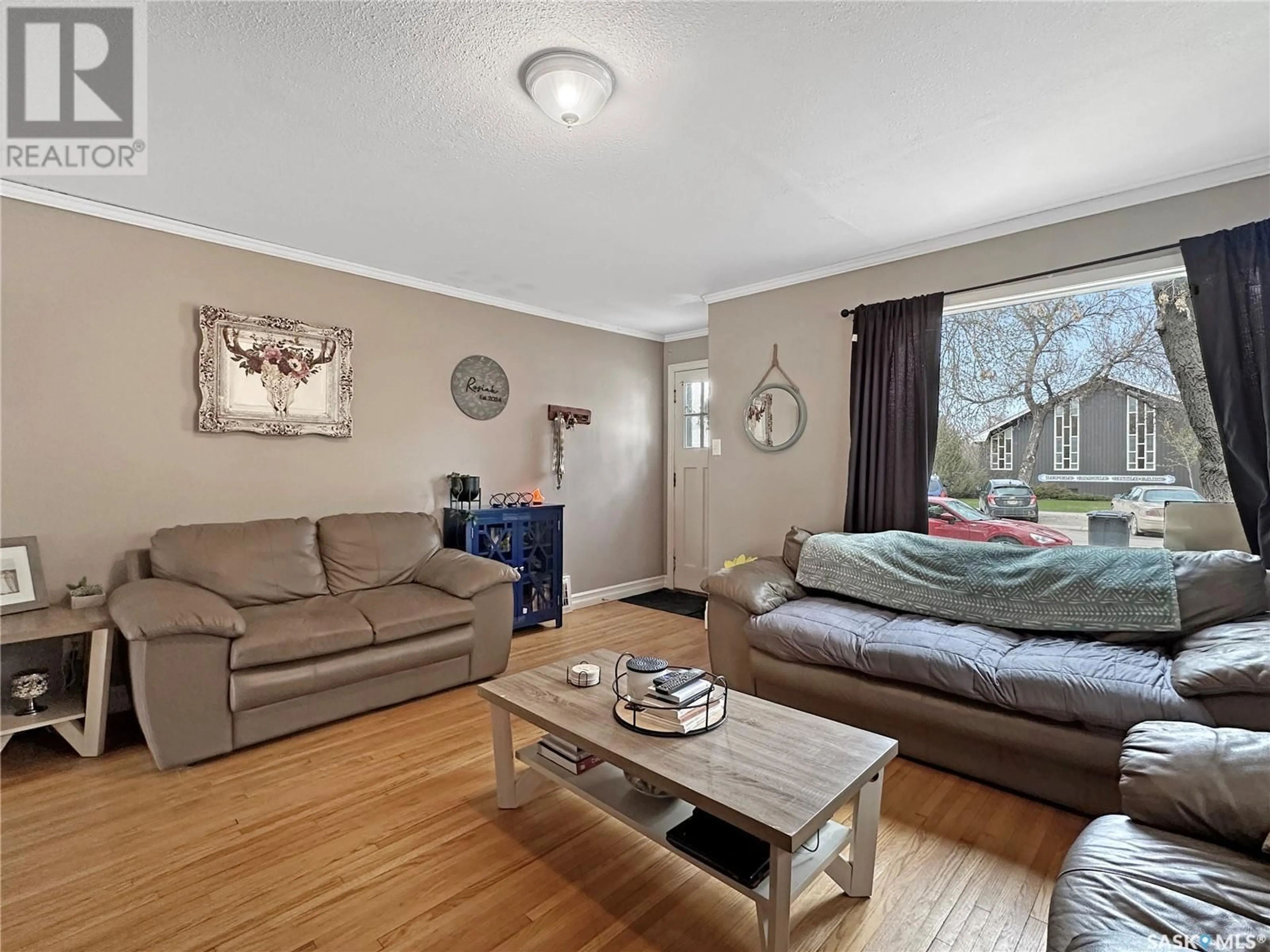 Living room with furniture, wood/laminate floor for 804 BUXTON STREET, Indian Head Saskatchewan S0G2K0