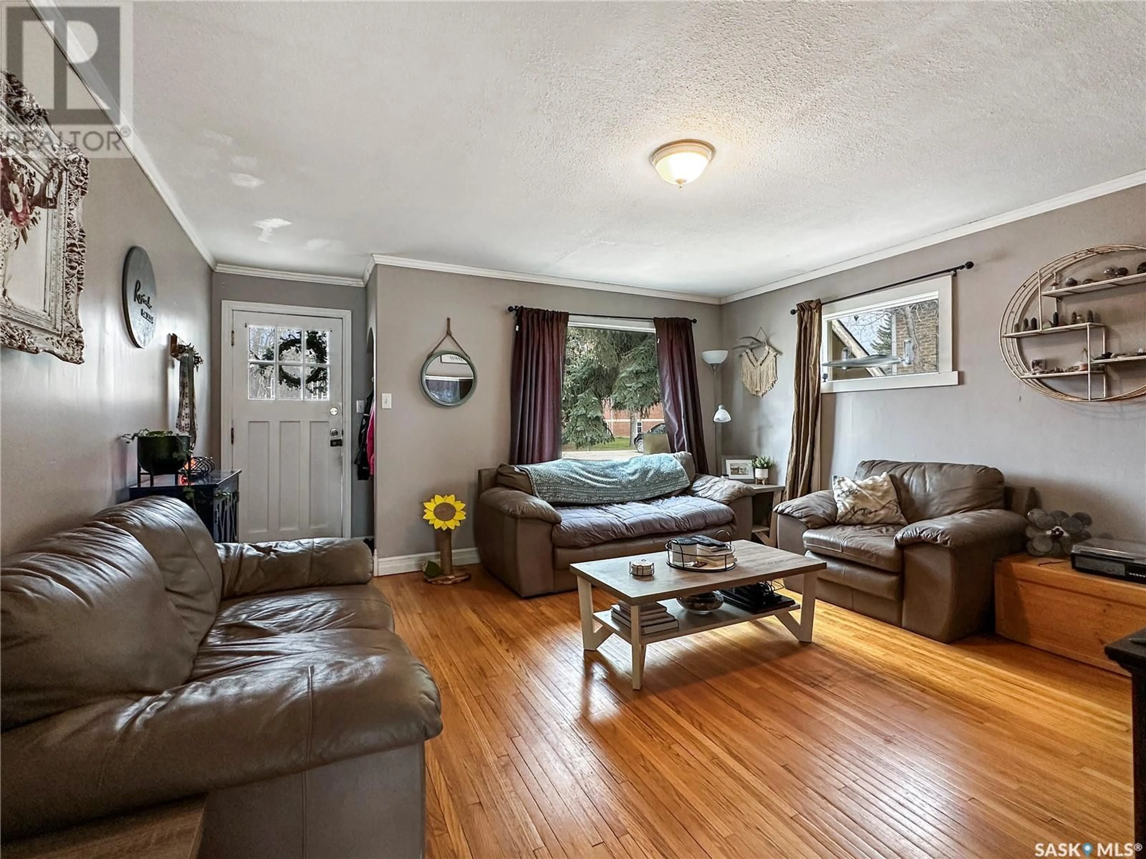Living room with furniture, wood/laminate floor for 804 BUXTON STREET, Indian Head Saskatchewan S0G2K0