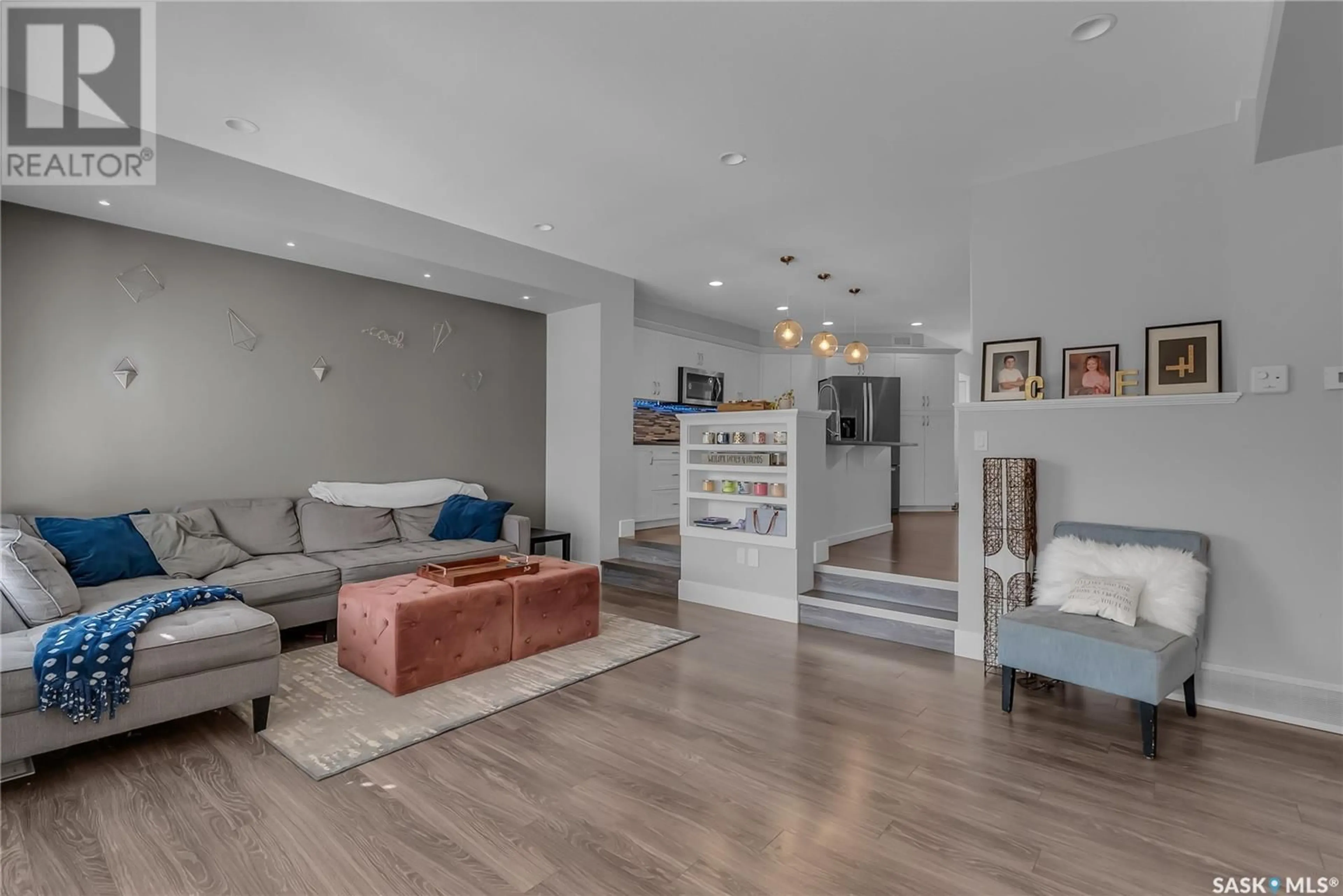 Living room with furniture, wood/laminate floor for 331 EATON LANE, Saskatoon Saskatchewan S7V0H4