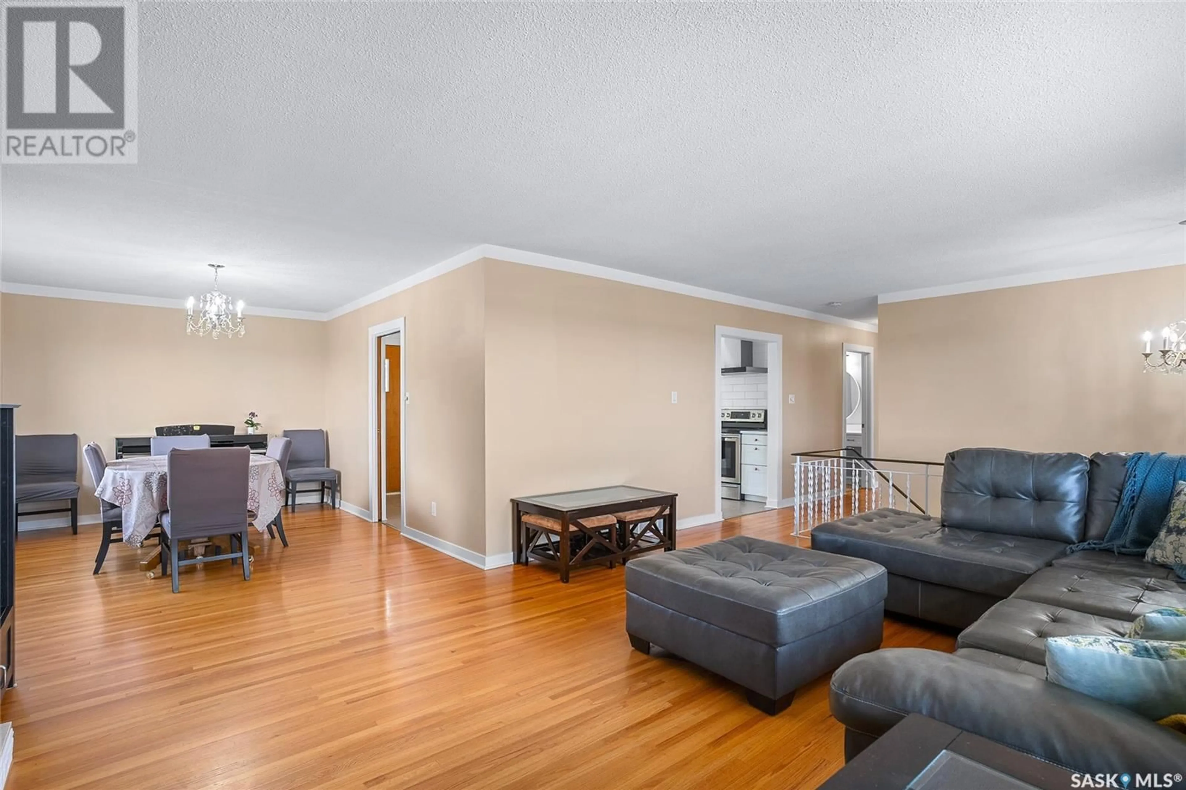 Living room with furniture, wood/laminate floor for 27 WEIR CRESCENT, Saskatoon Saskatchewan S7H3A8