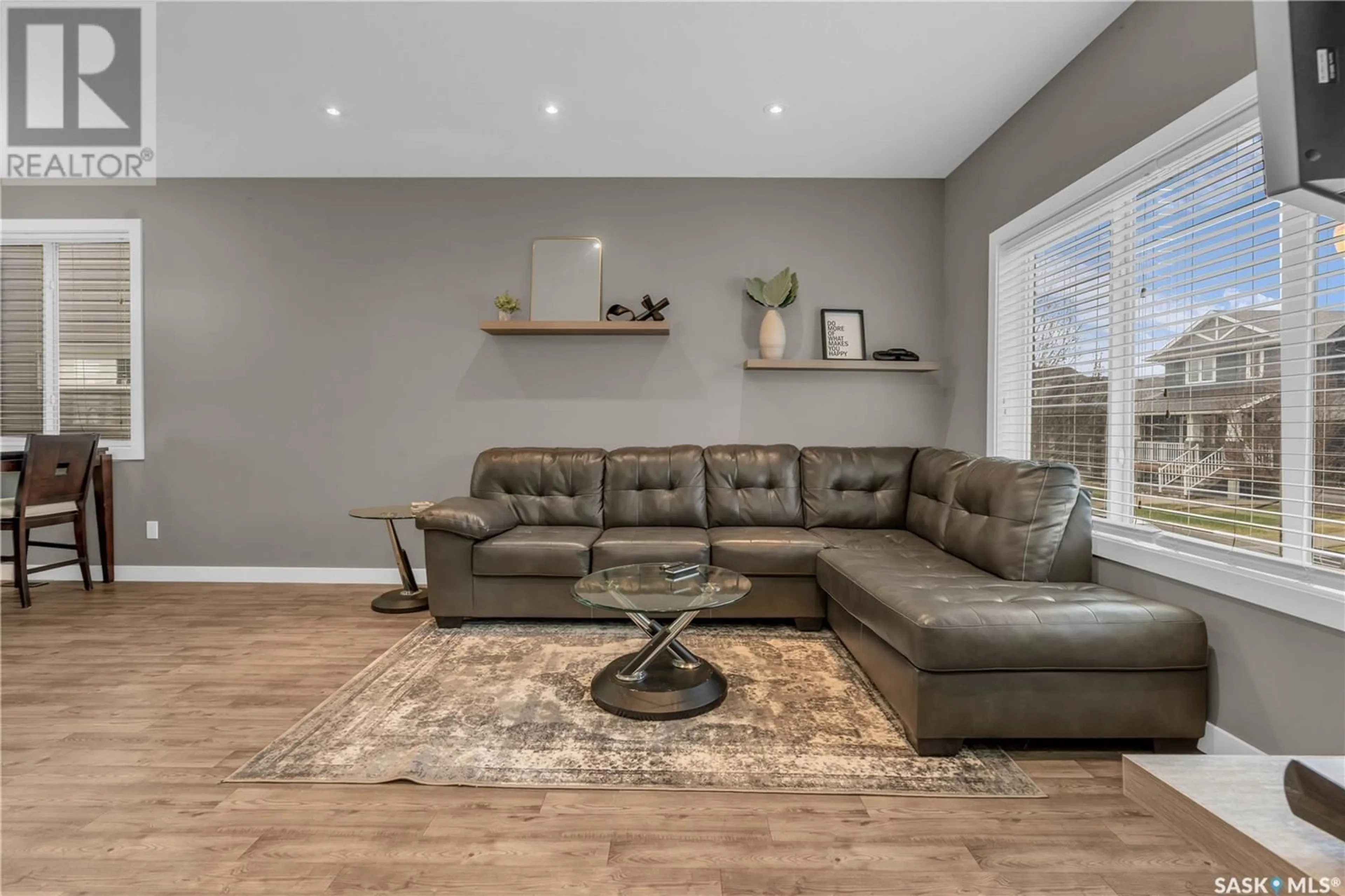 Living room with furniture, wood/laminate floor for 5438 MCCLELLAND DRIVE, Regina Saskatchewan S4W0K8