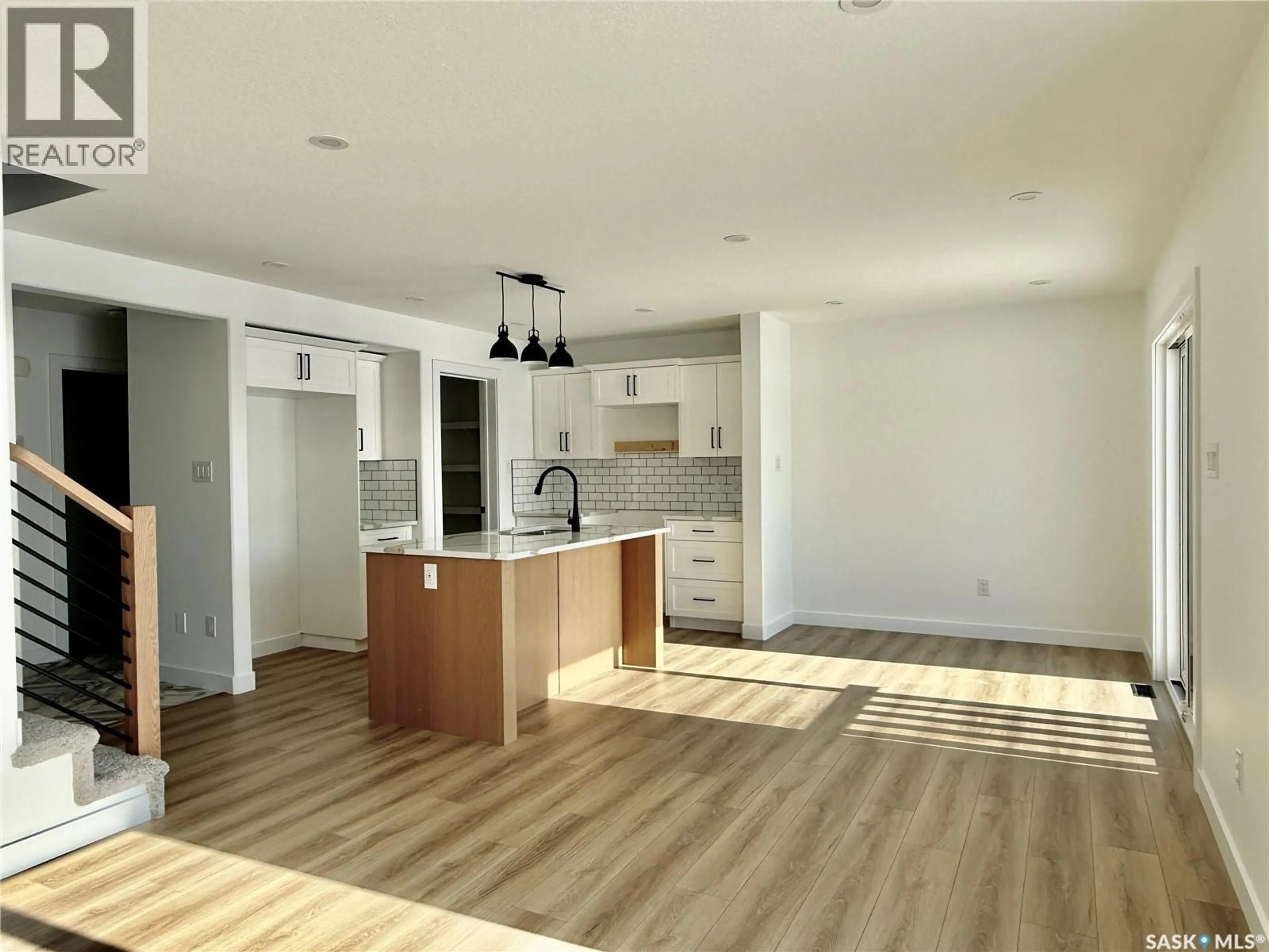 Open concept kitchen, wood/laminate floor for 174 DORAN WAY, Saskatoon Saskatchewan S7V0Z7
