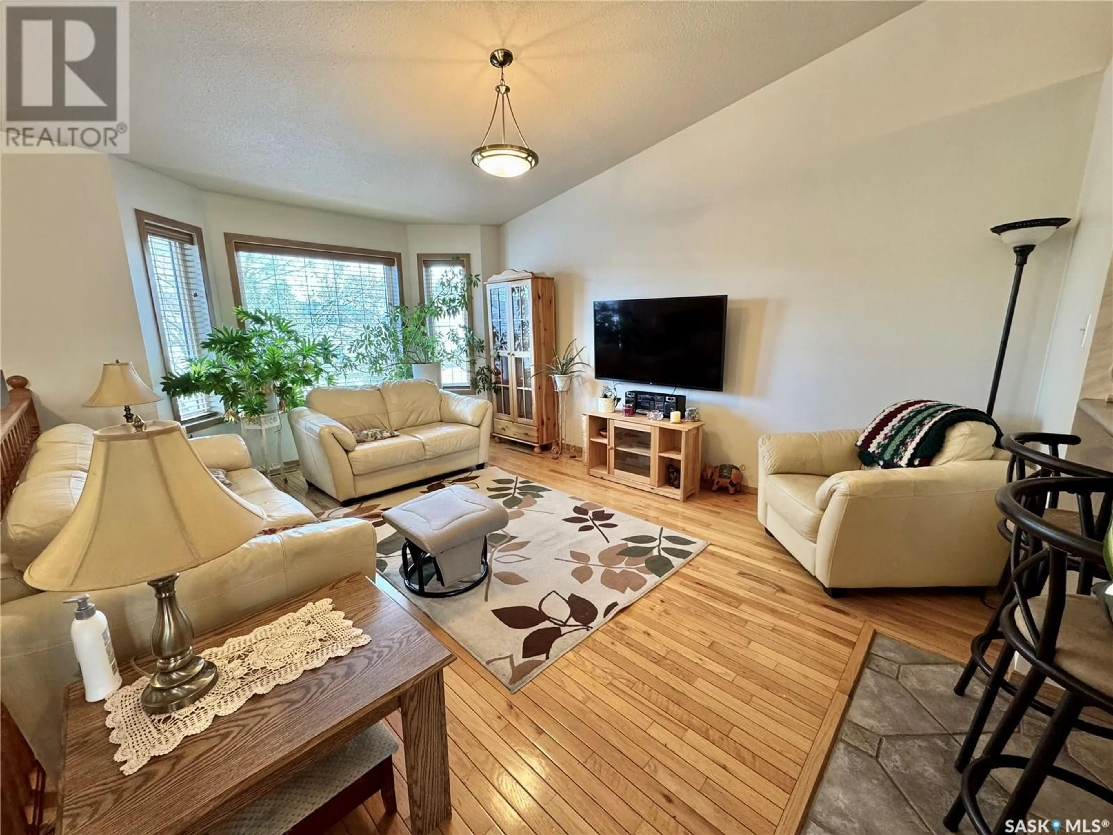 Living room with furniture, wood/laminate floor for 433 ADAMS CRESCENT, Prince Albert Saskatchewan S6V7K6