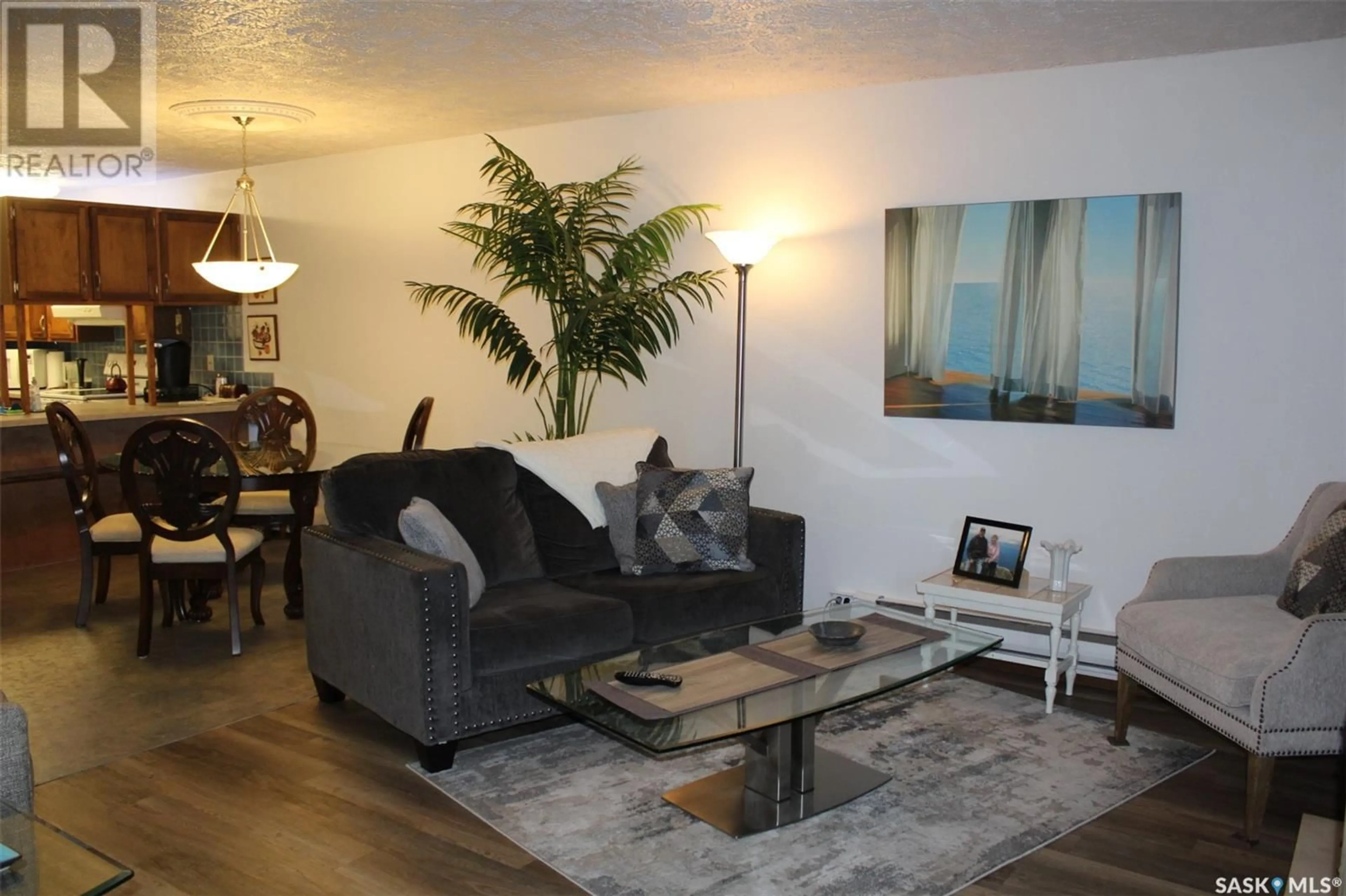 Living room with furniture, wood/laminate floor for 13 228 3RD STREET, Weyburn Saskatchewan S4H0W6