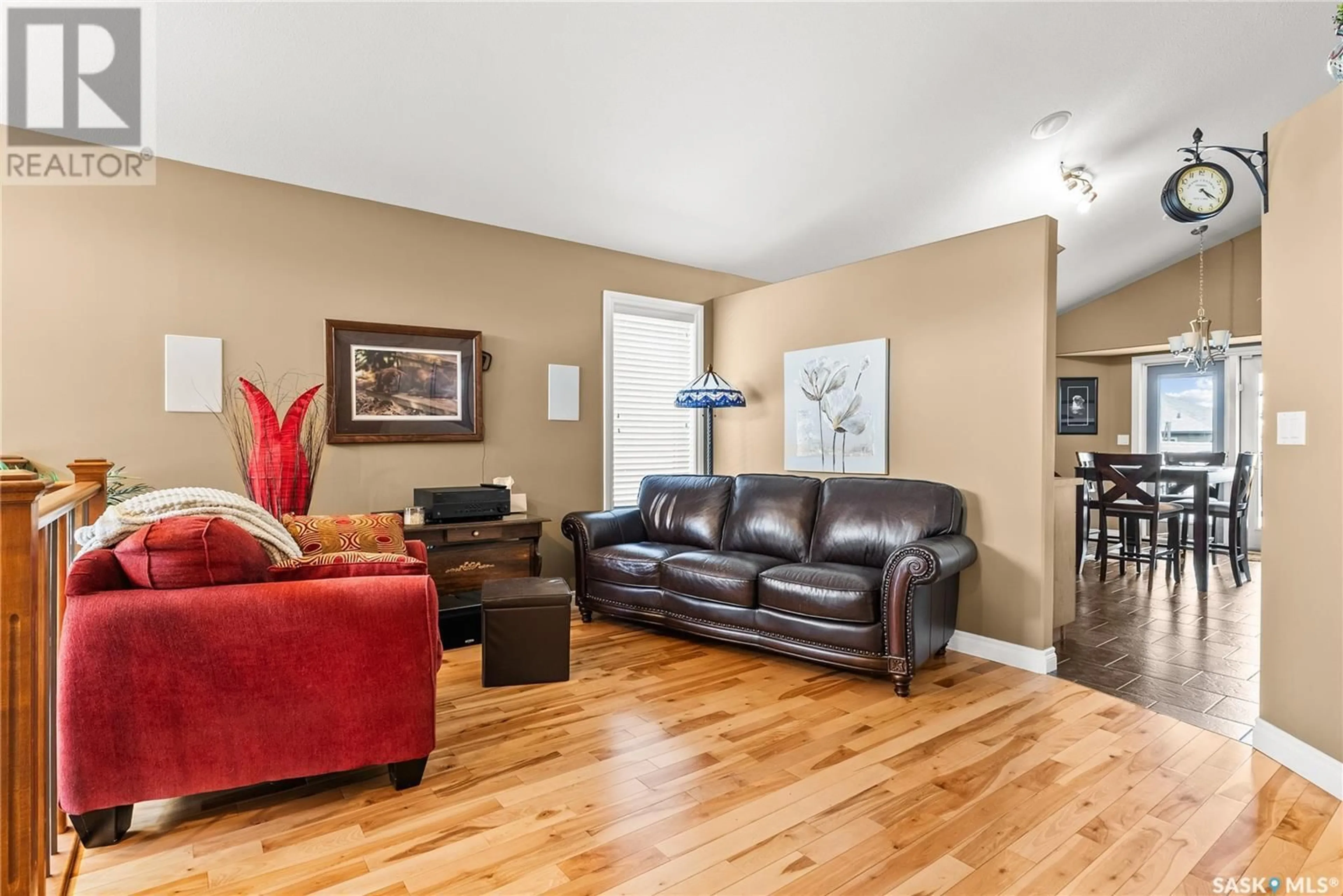 Living room with furniture, wood/laminate floor for 206 KOROL CRESCENT, Saskatoon Saskatchewan S7R0E1