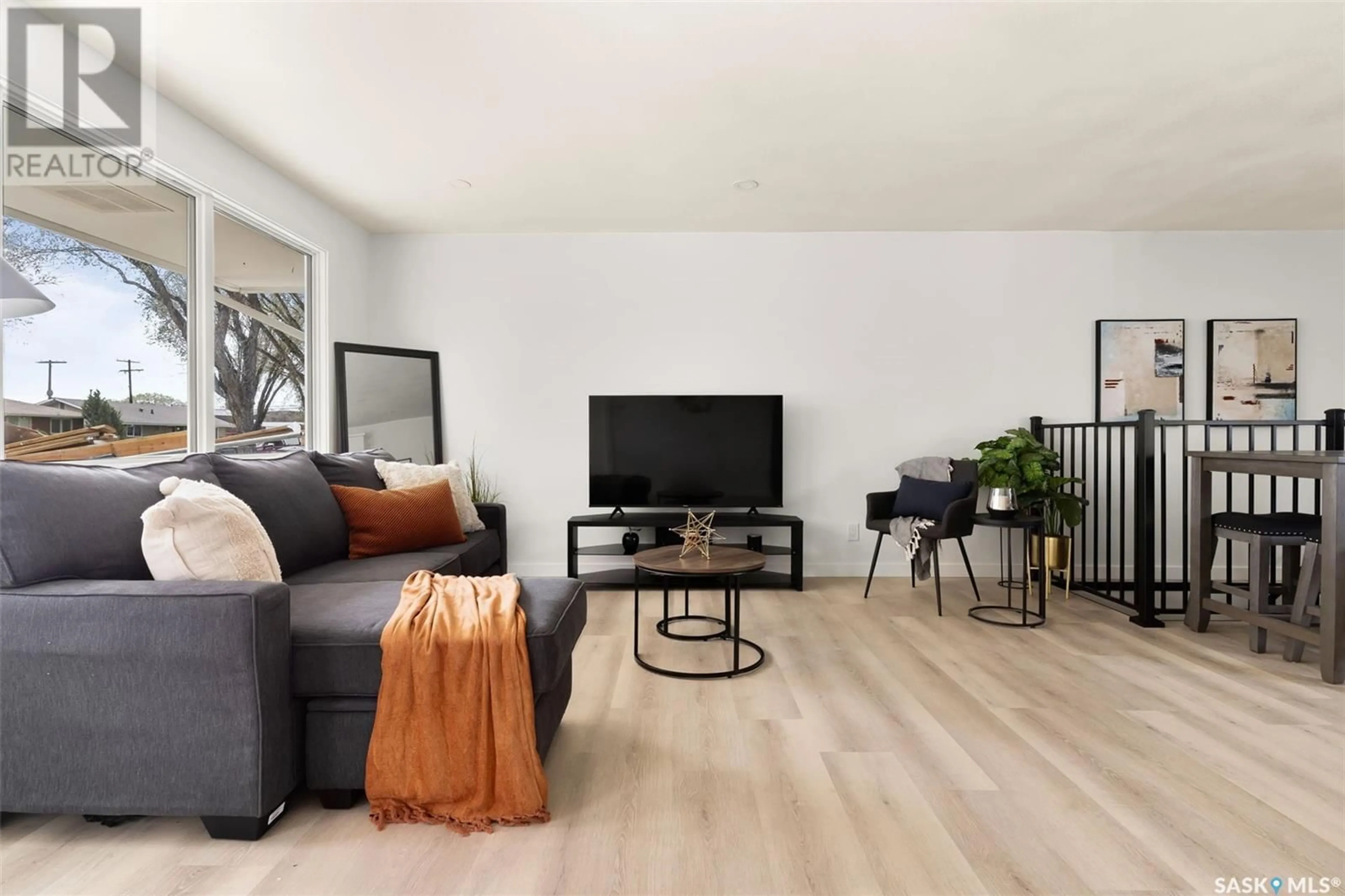 Living room with furniture, wood/laminate floor for 1612 8TH AVENUE, Regina Saskatchewan S4R0G3