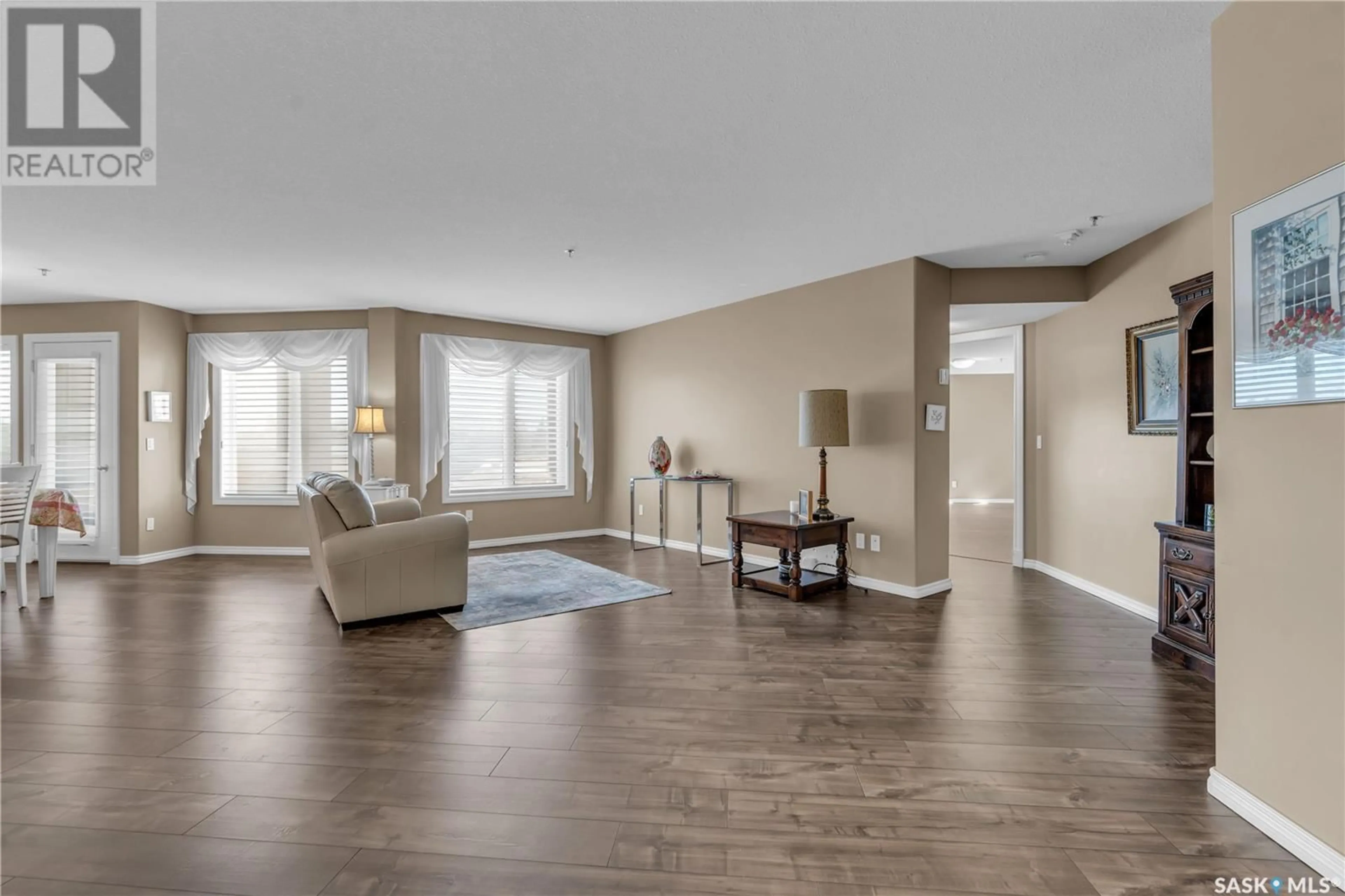Living room with furniture, wood/laminate floor for 204 - 3101 RENFREW CRESCENT, Regina Saskatchewan S4V3B6