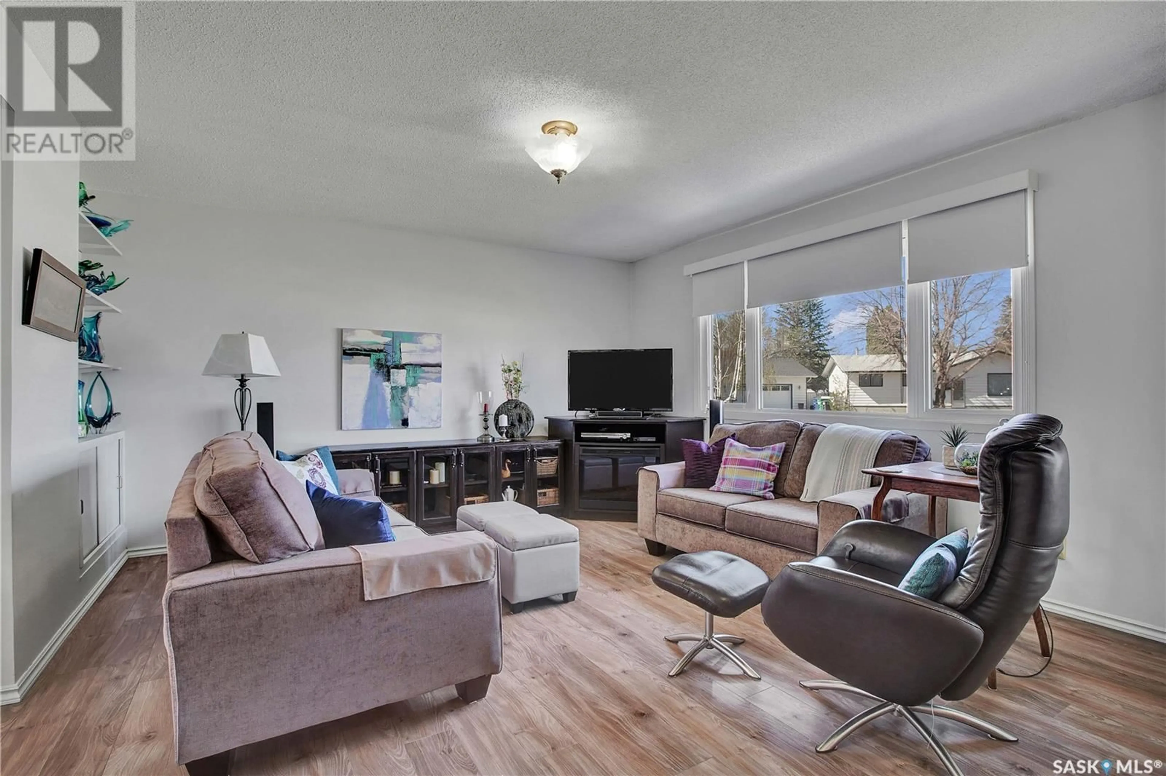 Living room with furniture, wood/laminate floor for 26 MURDOCH PLACE, Saskatoon Saskatchewan S7L4G9