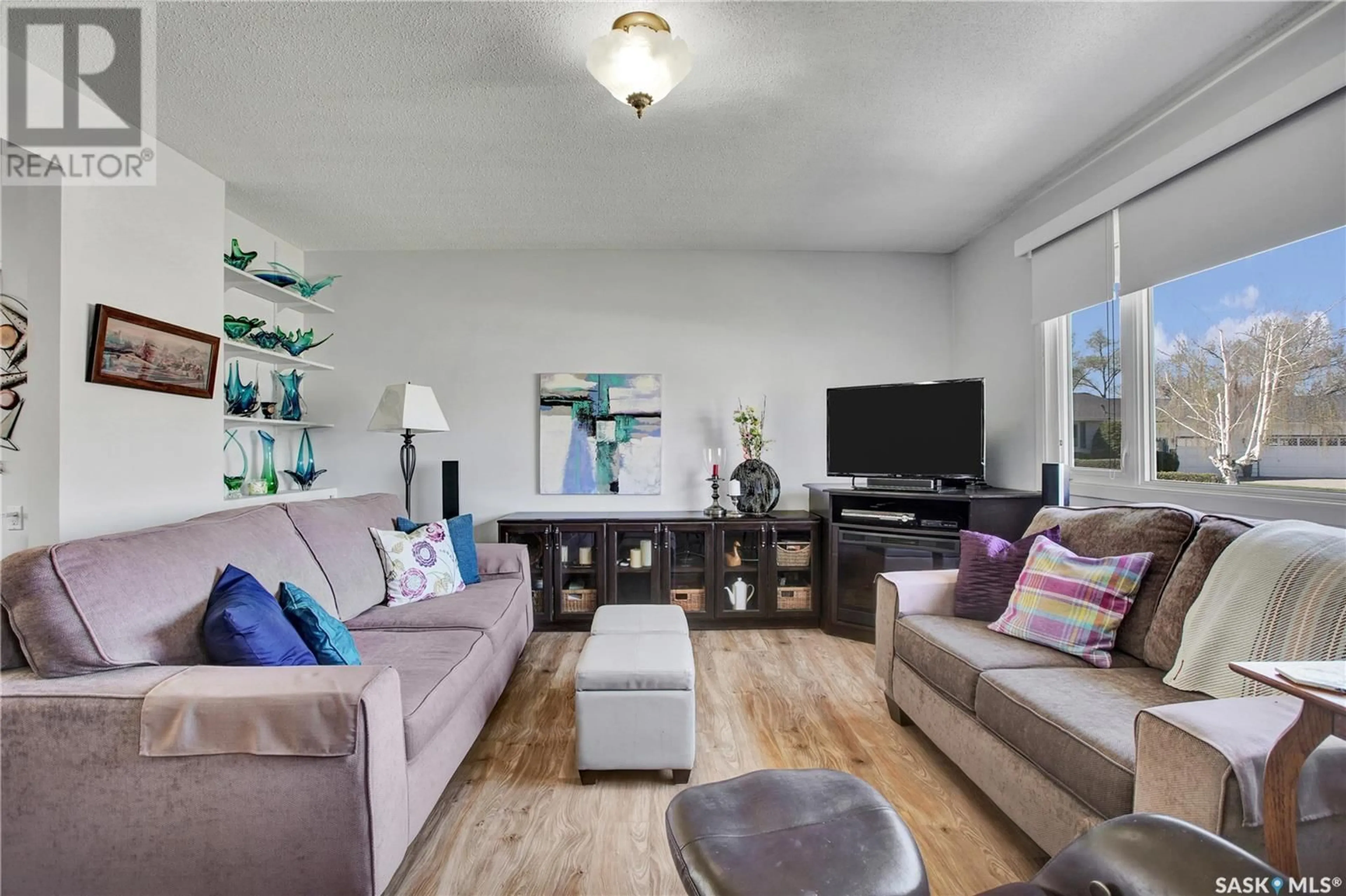 Living room with furniture, wood/laminate floor for 26 MURDOCH PLACE, Saskatoon Saskatchewan S7L4G9