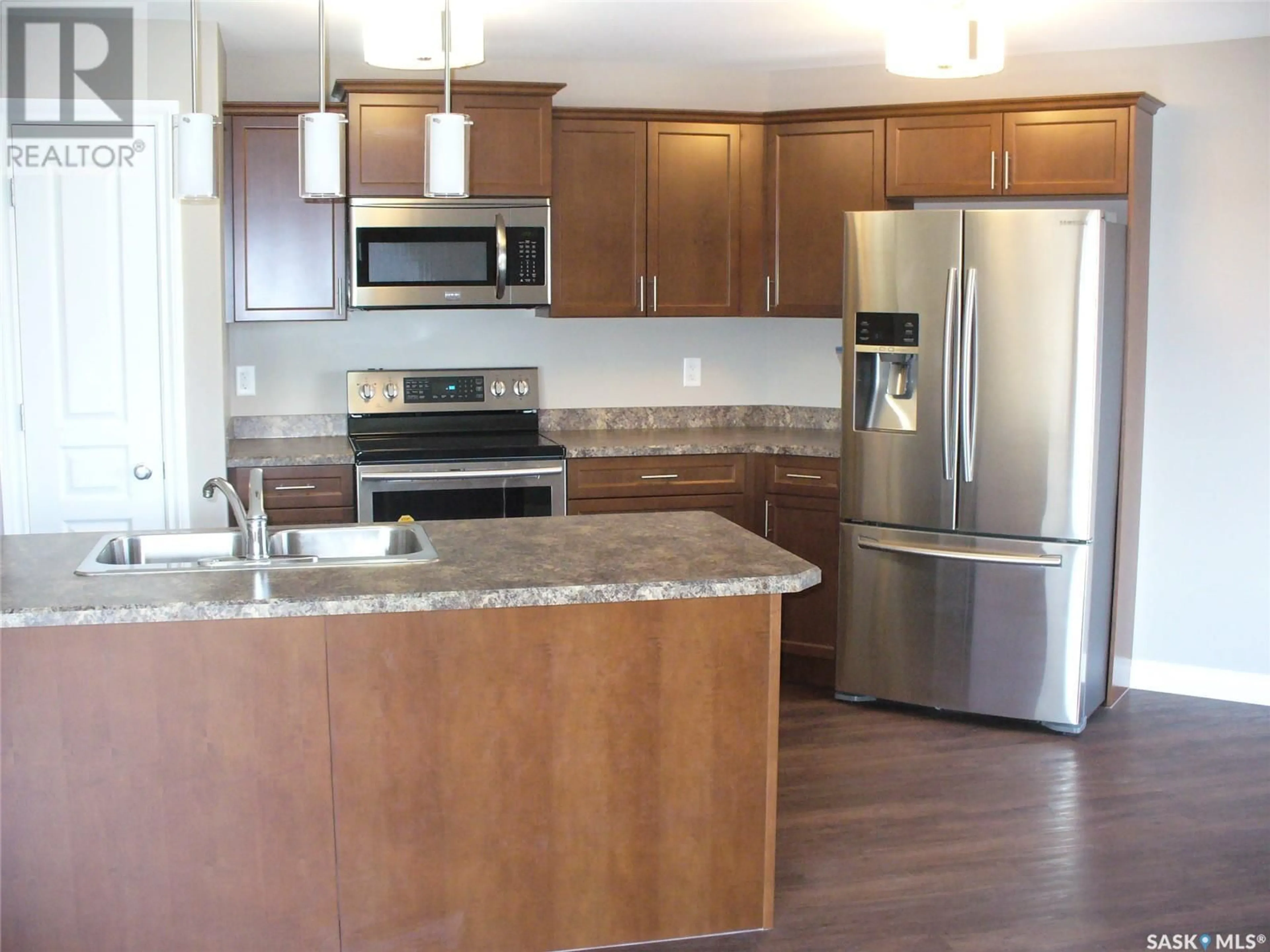 Open concept kitchen, wood/laminate floor for E - 231 3630 HAUGHTON ROAD, Regina Saskatchewan S4V1P1