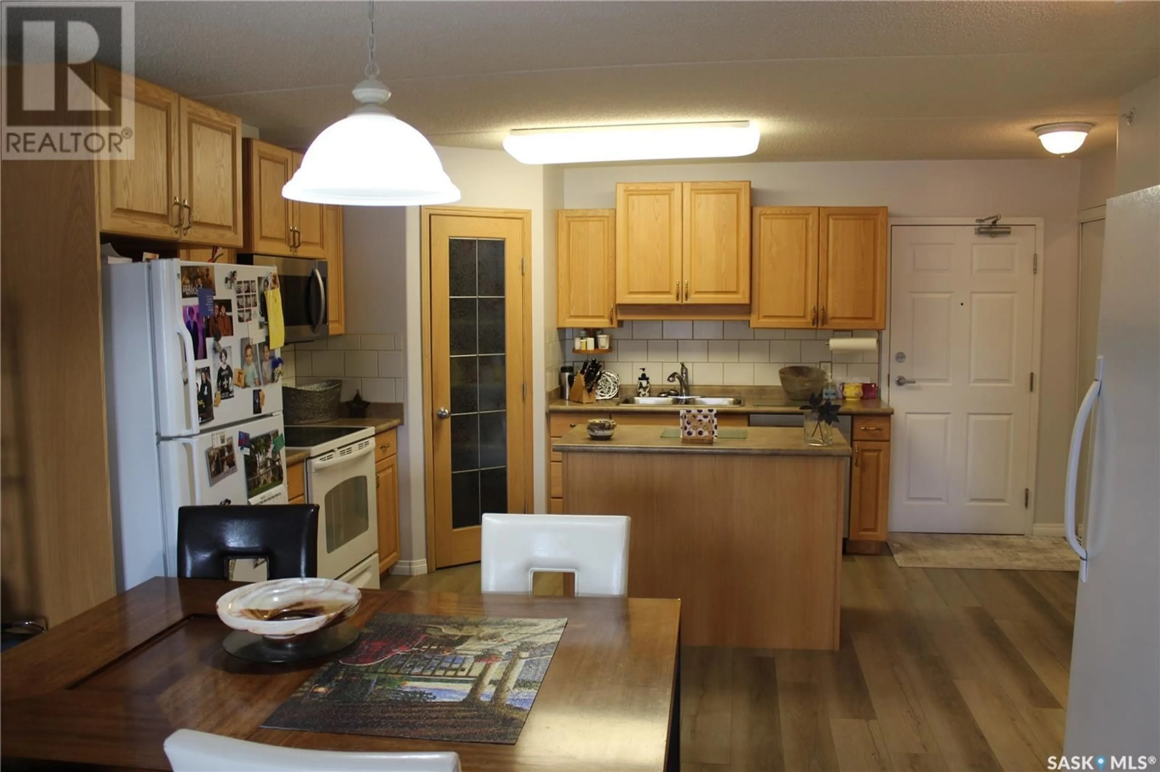 Open concept kitchen, wood/laminate floor for 206 - 1637 FIRST STREET, Estevan Saskatchewan S4A2X4
