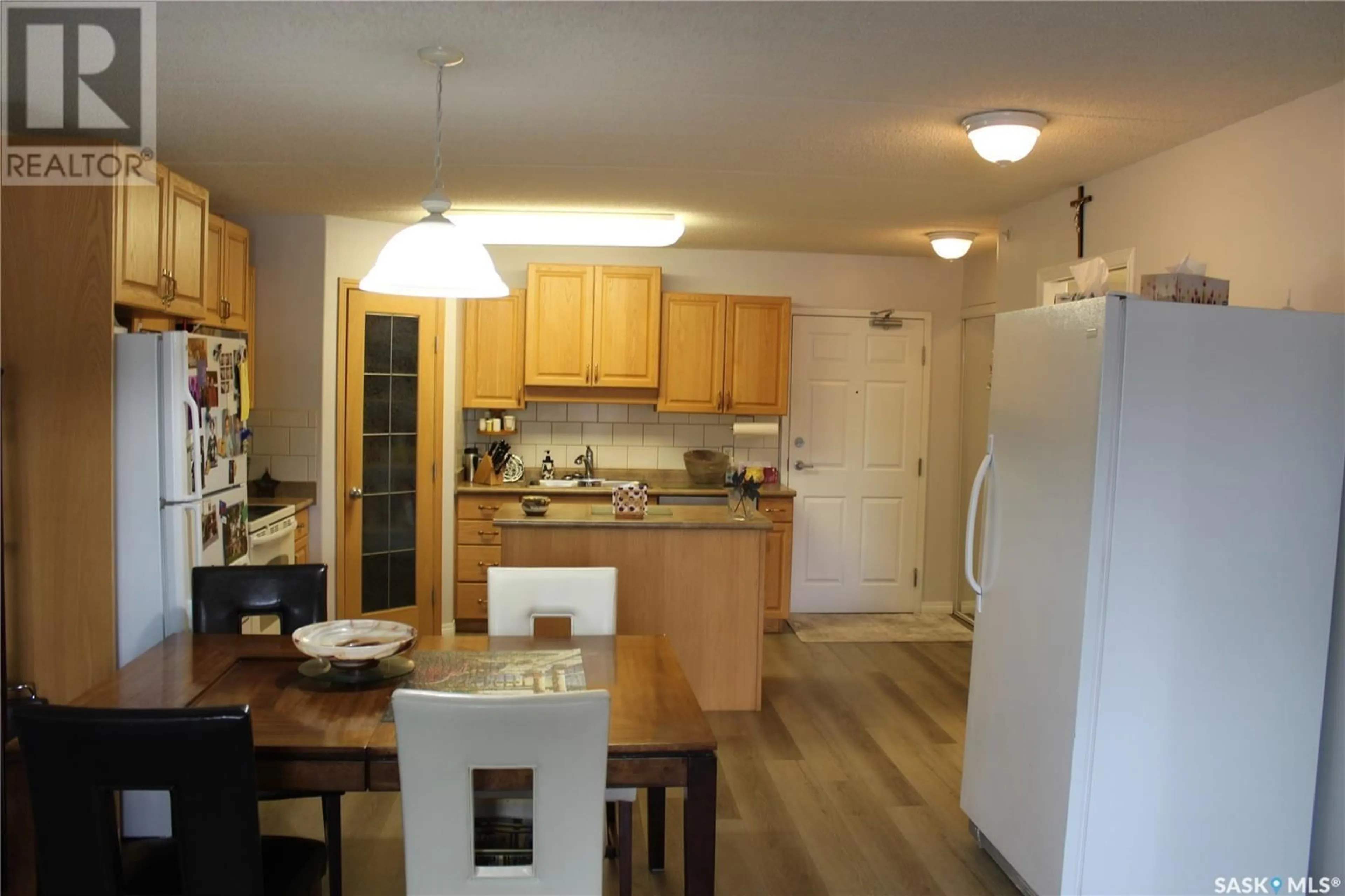 Open concept kitchen, wood/laminate floor for 206 - 1637 FIRST STREET, Estevan Saskatchewan S4A2X4