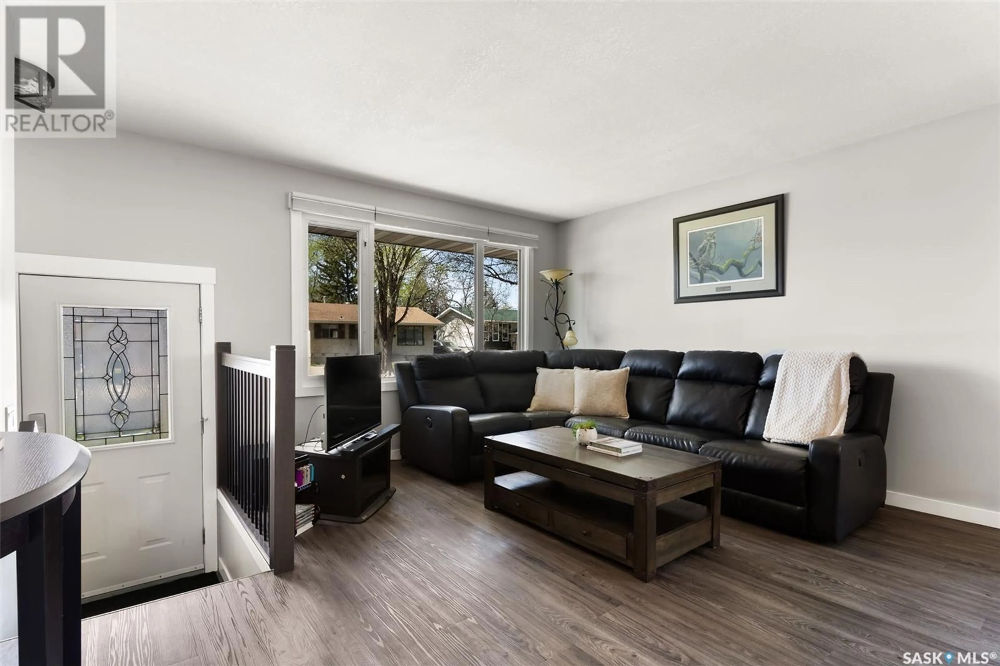 Living room with furniture, wood/laminate floor for 114 COLEMAN CRESCENT, Regina Saskatchewan S4N5J5