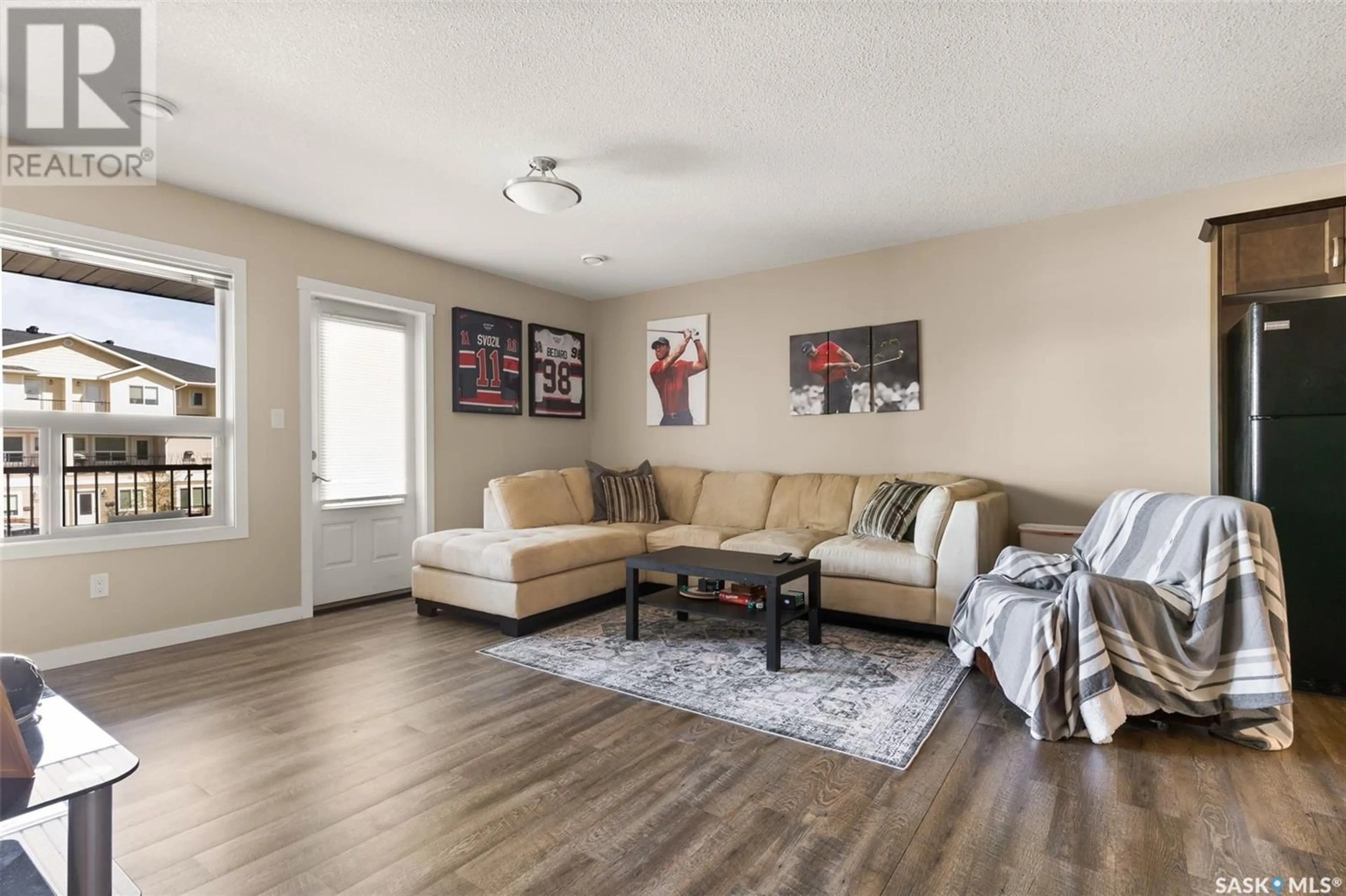 Living room with furniture, wood/laminate floor for 212 1220 EMPRESS STREET, Regina Saskatchewan S4T1G7