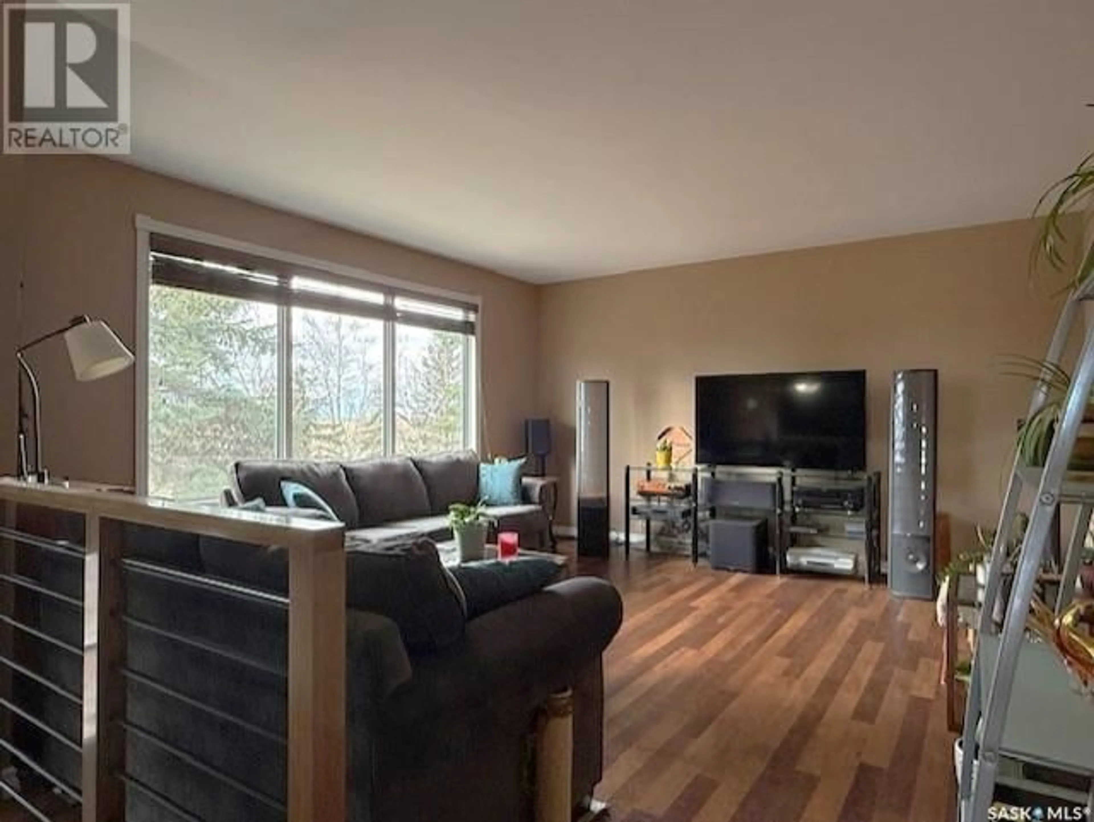 Living room with furniture, wood/laminate floor for 2062 RM OF CANA ACREAGE, Cana Rm No. 214 Saskatchewan S0A2P0