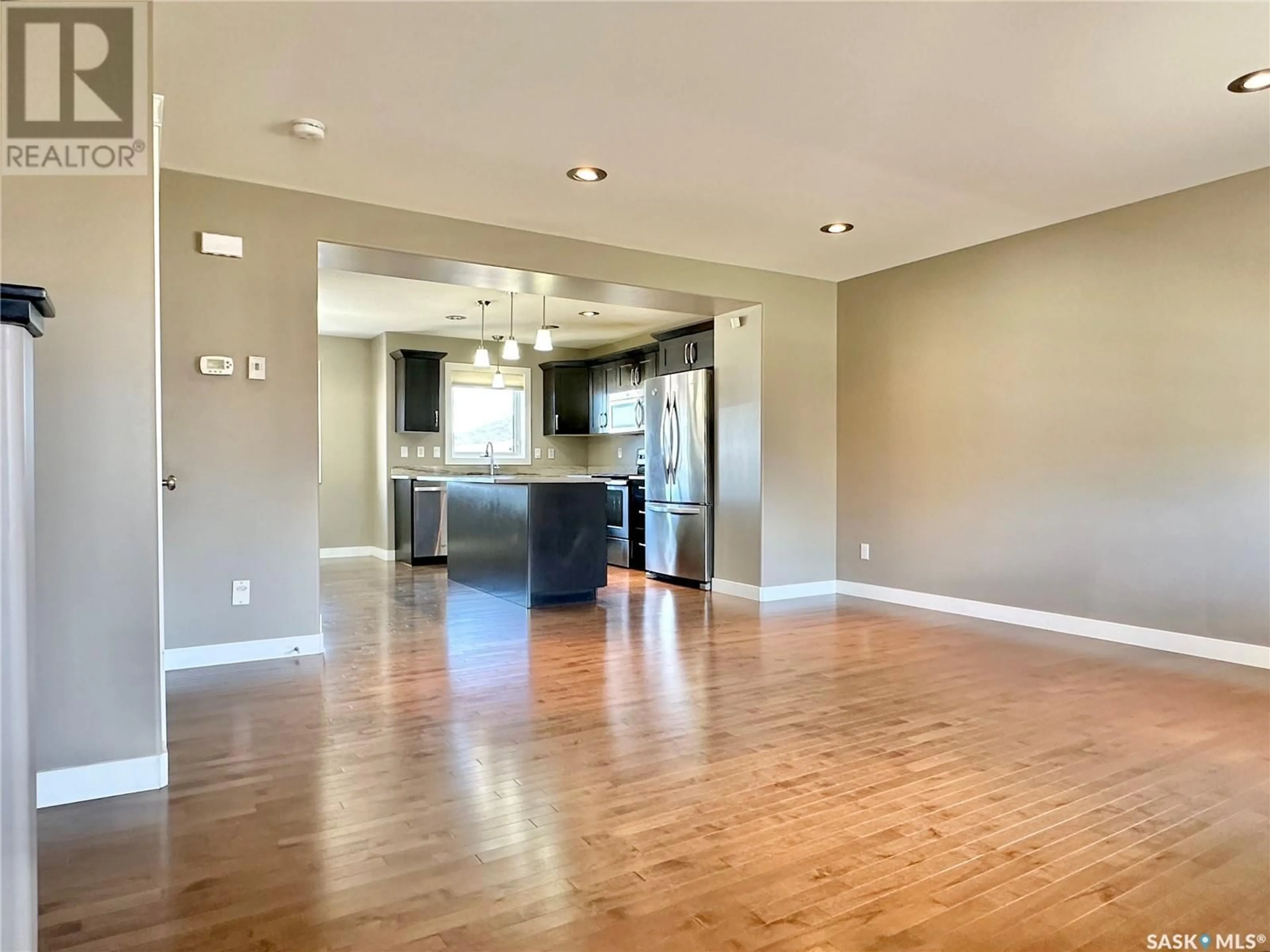 Open concept kitchen, wood/laminate floor for 3822 33RD STREET, Saskatoon Saskatchewan S7R0M1