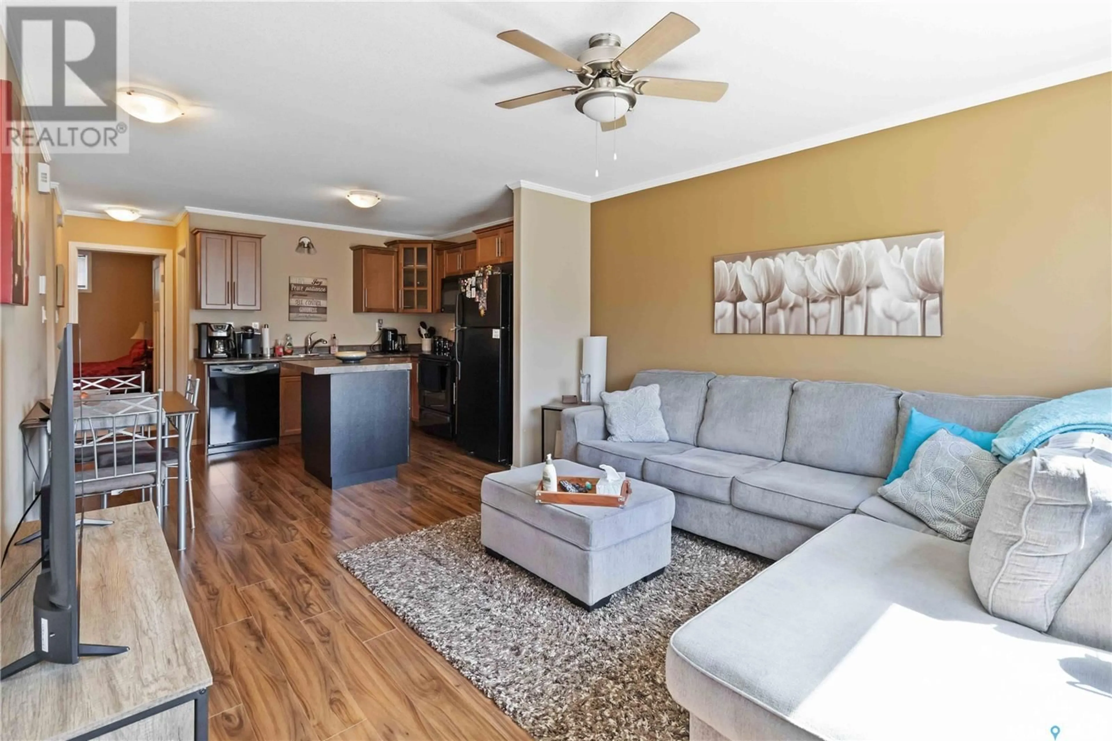 Living room with furniture, wood/laminate floor for 110 - 809 SHILLINGTON CRESCENT, Saskatoon Saskatchewan S7M3Z8