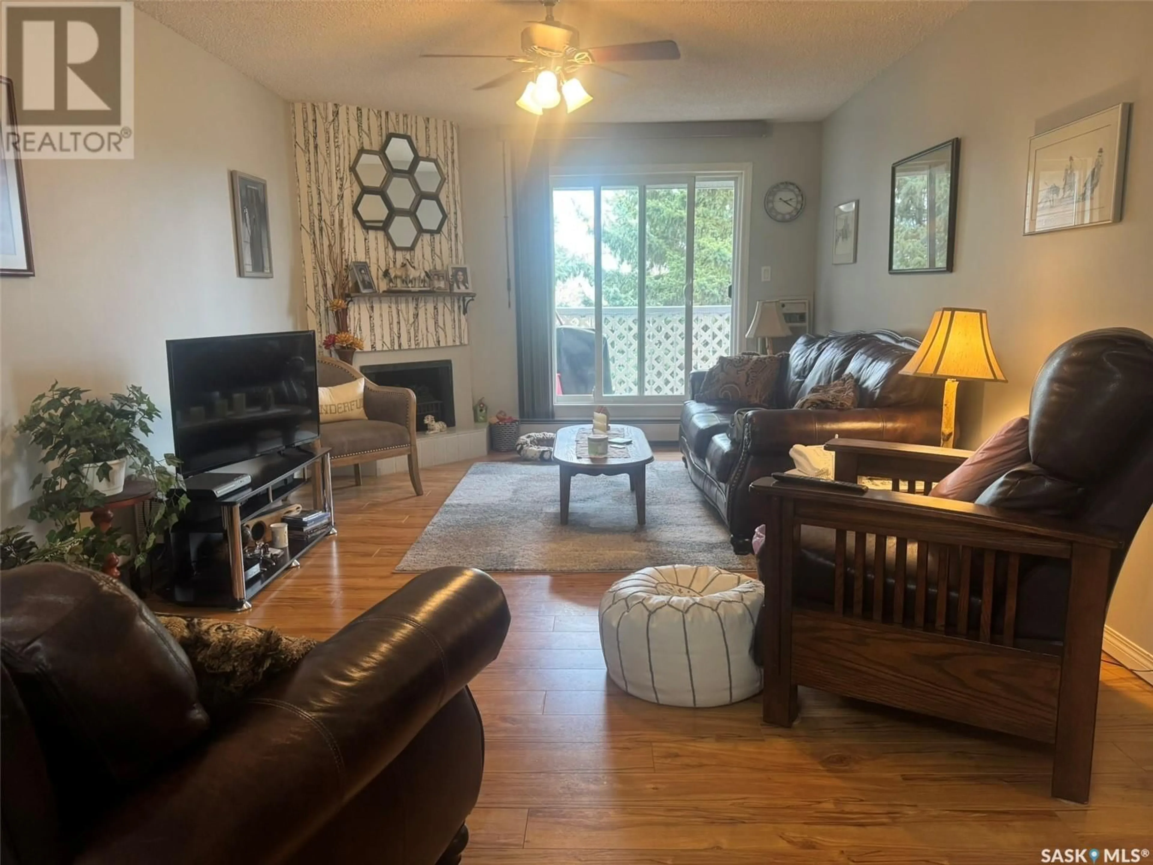 Living room with furniture, wood/laminate floor for 303 1808 EAGLESHAM AVENUE, Weyburn Saskatchewan S4H3A8